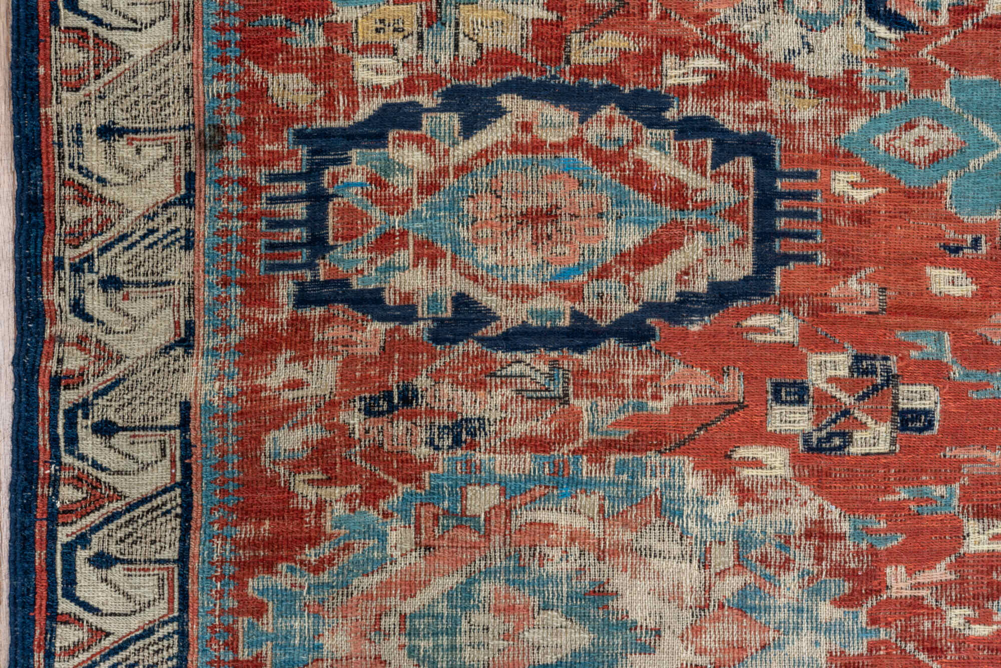 5' x 7' one-of-a-kind handmade vintage Sumak rug. Color palette: black, blue, brown, charcoal, dark gray, gray, pink, red