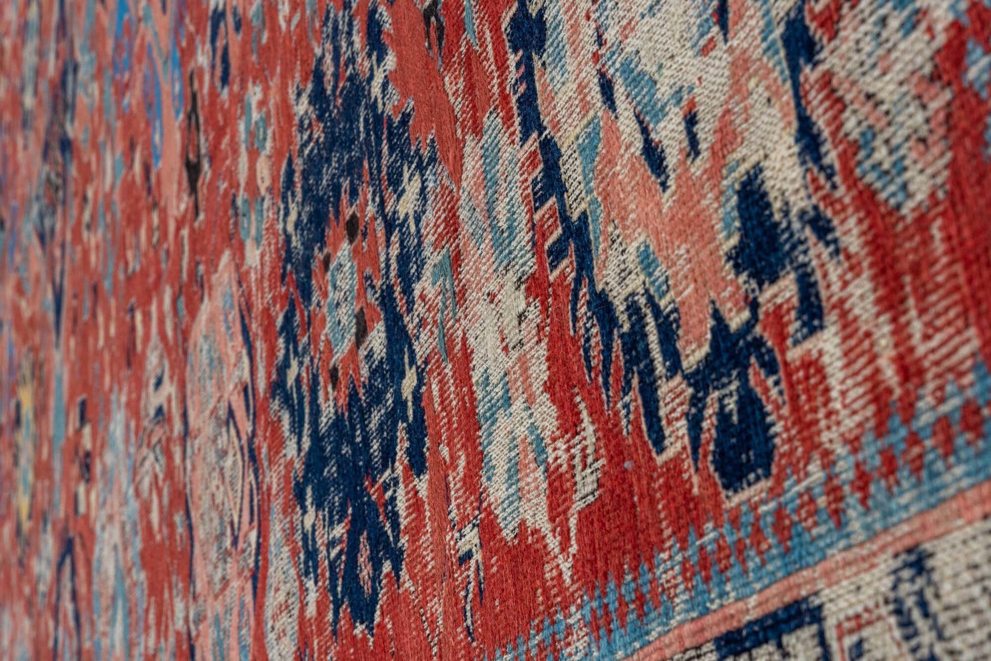 5' x 7' one-of-a-kind handmade vintage Sumak rug. Color palette: black, blue, brown, charcoal, dark gray, gray, pink, red
