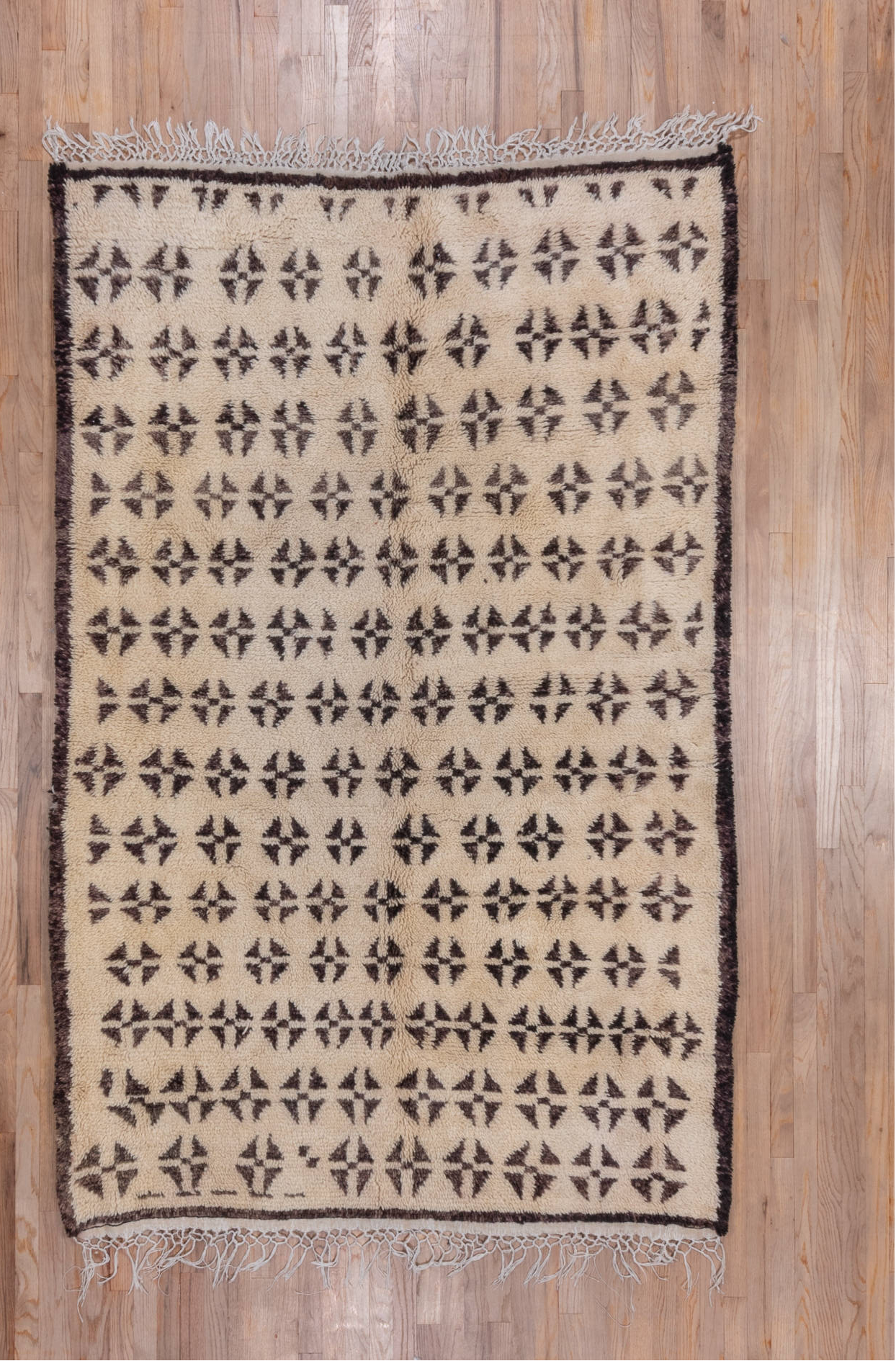 5' x 8' one-of-a-kind handmade vintage Moroccan medium size rug. Color palette: brown, gray, light gray, off-white, orange