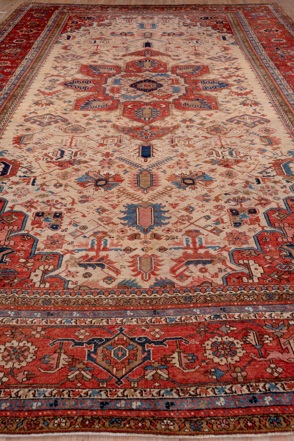 12' x 18' one-of-a-kind handmade antique Serapi oversize rug. Color palette: ivory, rust, brick red, indigo, sky blue, camel
