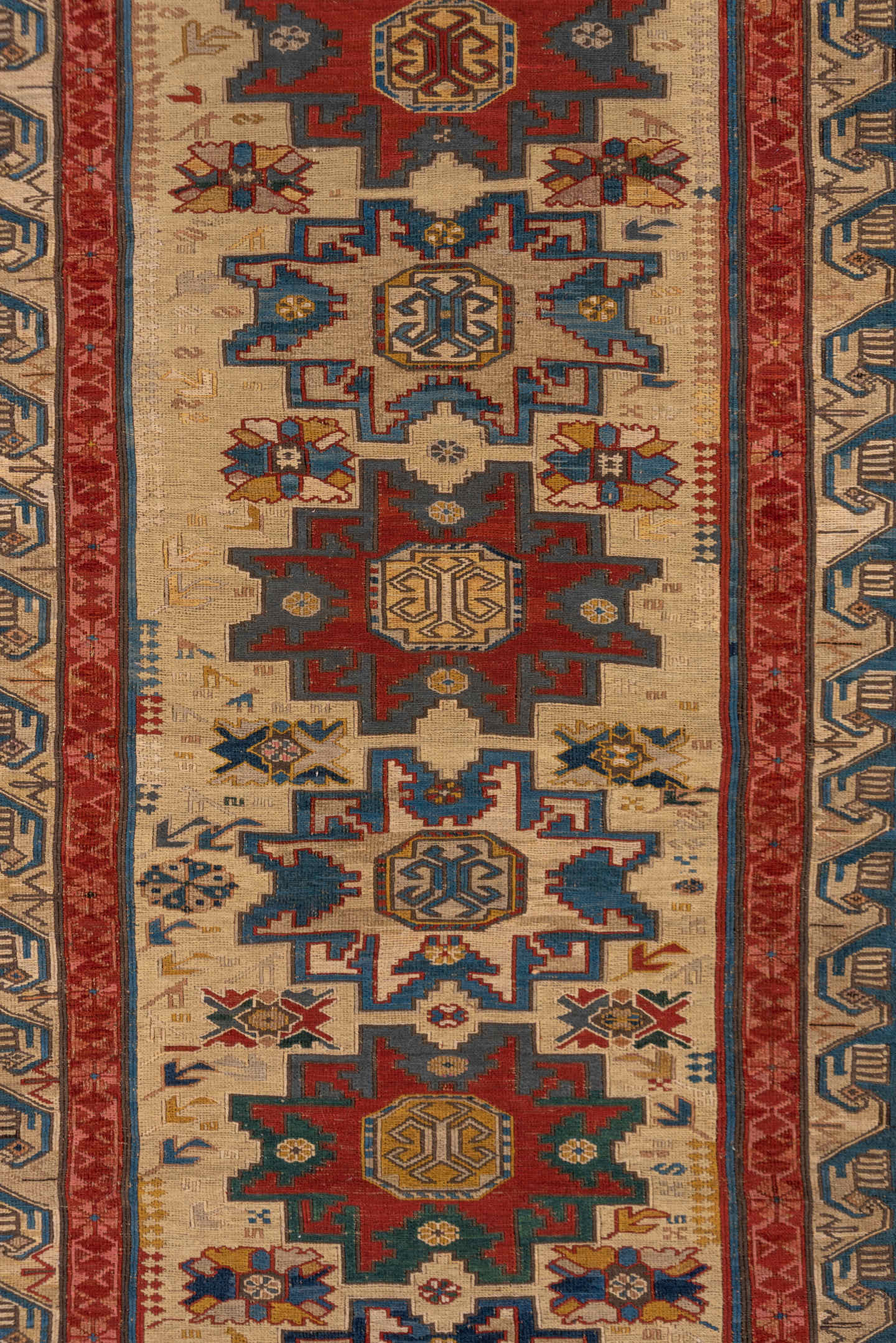 3' x 8' one-of-a-kind handmade antique Sumak runner rug. Color palette: ivory, rust, indigo, blue, gold, sage, camel