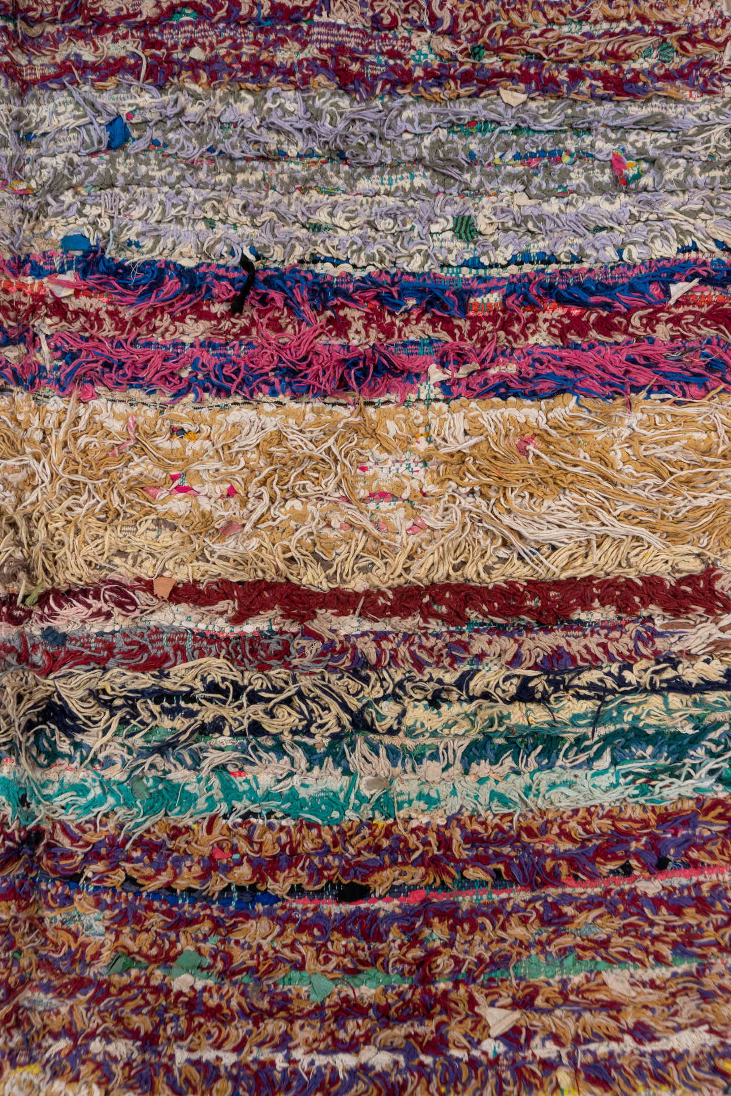 4' x 10' one-of-a-kind handmade vintage Rag Rug runner rug. Color palette: ivory, burgundy, teal, tan, blue, cream, red