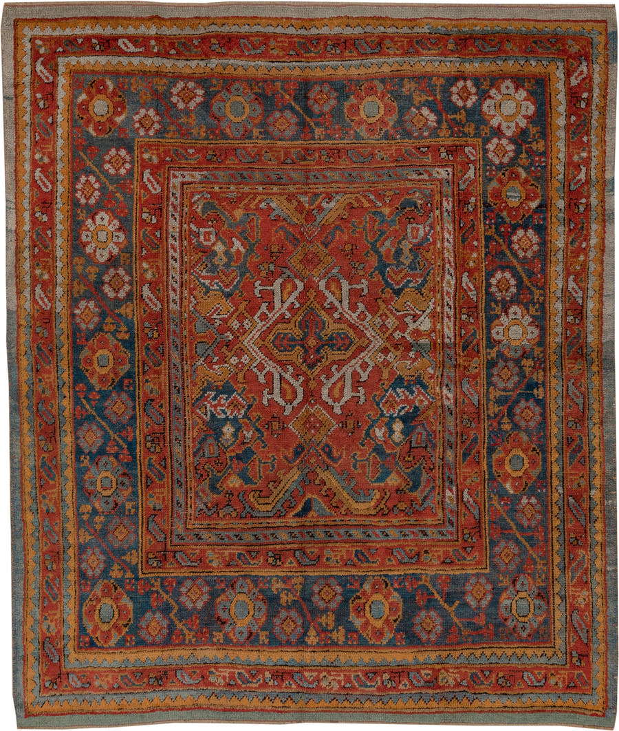 7' x 8' one-of-a-kind handmade antique Oushak rug. Color palette: rust, blue, gold, ivory, slate, terra cotta, charcoal