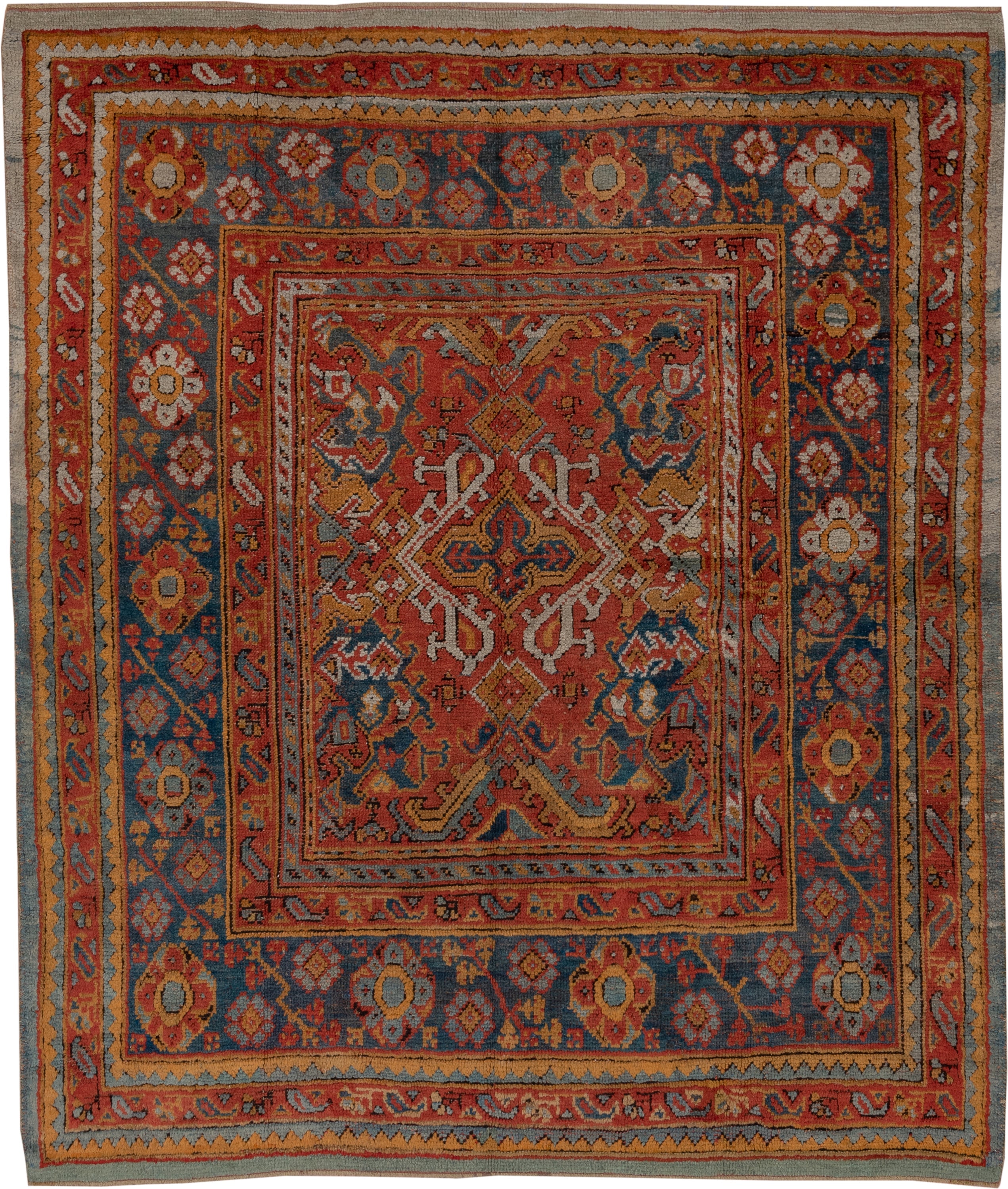 7' x 8' one-of-a-kind handmade antique Oushak rug. Color palette: rust, blue, gold, ivory, slate, terra cotta, charcoal