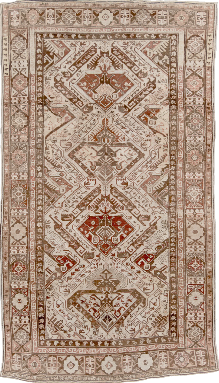5' x 10' one-of-a-kind handmade vintage Caucasian medium size rug. Color palette: brown, gray, light gray, off-white, orange