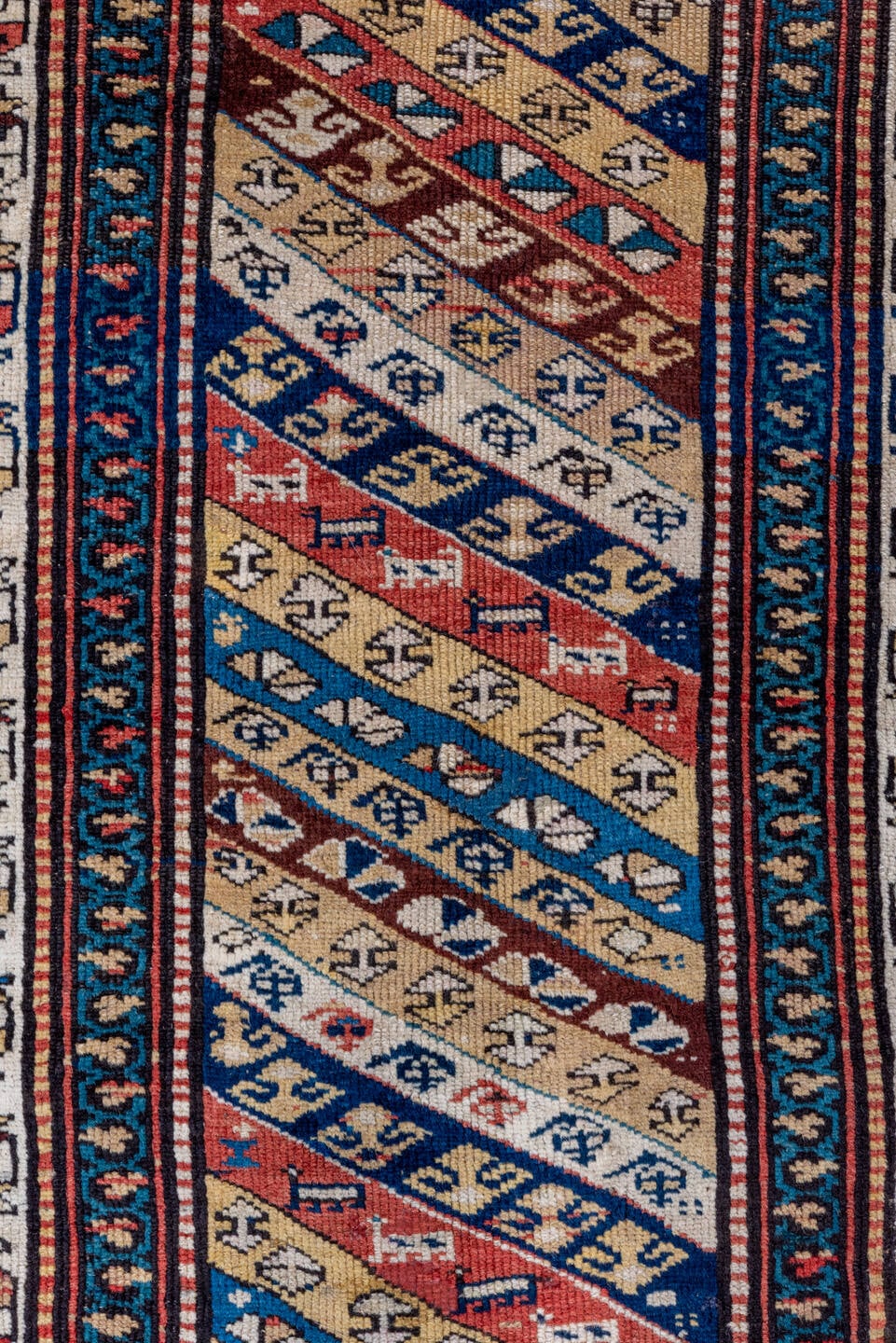 2' x 5' one-of-a-kind handmade antique Caucasian small size rug. Color palette: ivory, navy, rust, sky blue, brown, red