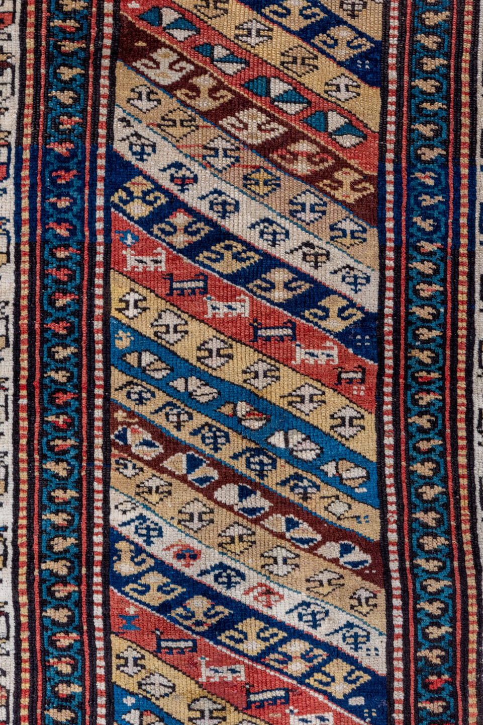 2' x 5' one-of-a-kind handmade antique Caucasian small size rug. Color palette: ivory, navy, rust, sky blue, brown, red