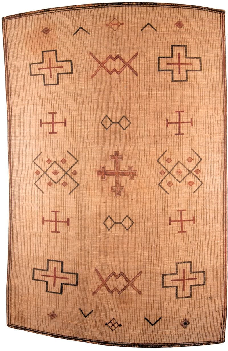 9' x 16' one-of-a-kind handmade vintage Tuareg rug. Color palette: camel, tan, rust, charcoal, terra cotta, beige