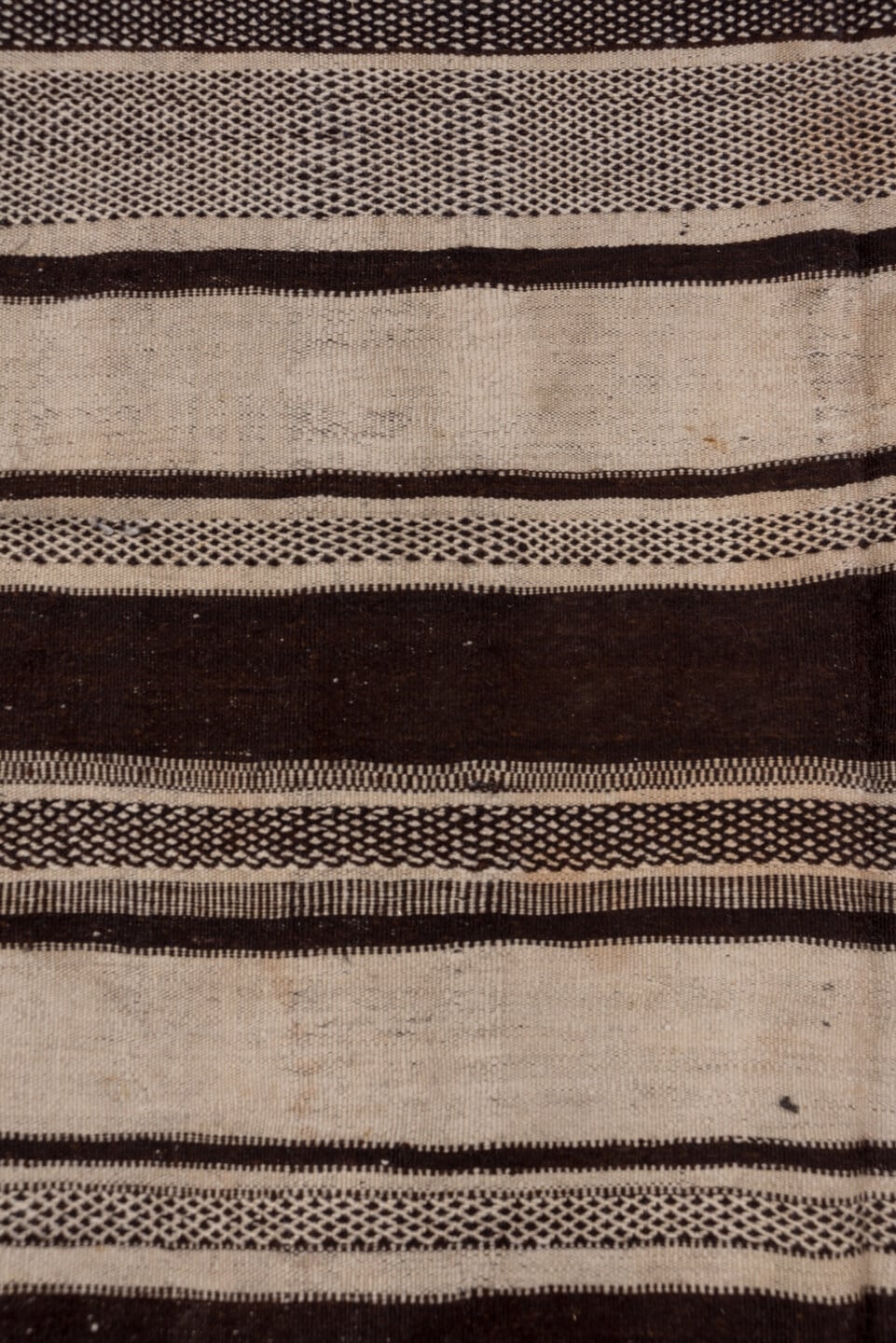 4' x 10' one-of-a-kind handmade vintage Blanket runner rug. Color palette: ivory, espresso, charcoal, taupe, brown, black