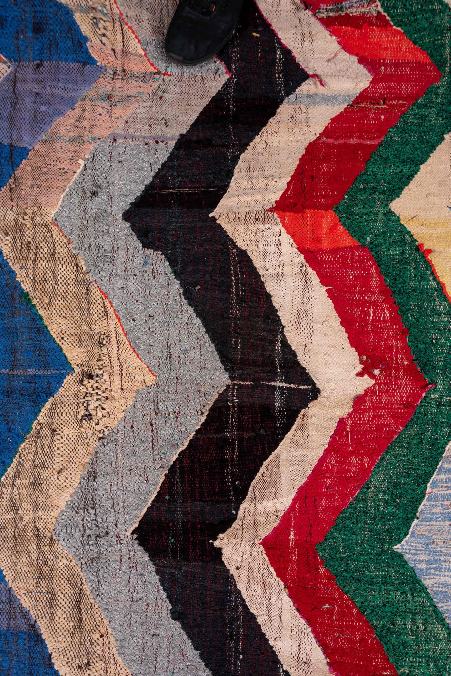 4' x 6' one-of-a-kind handmade vintage Rag Rug small size rug. Color palette: ivory, blue, charcoal, sky_blue, green, red