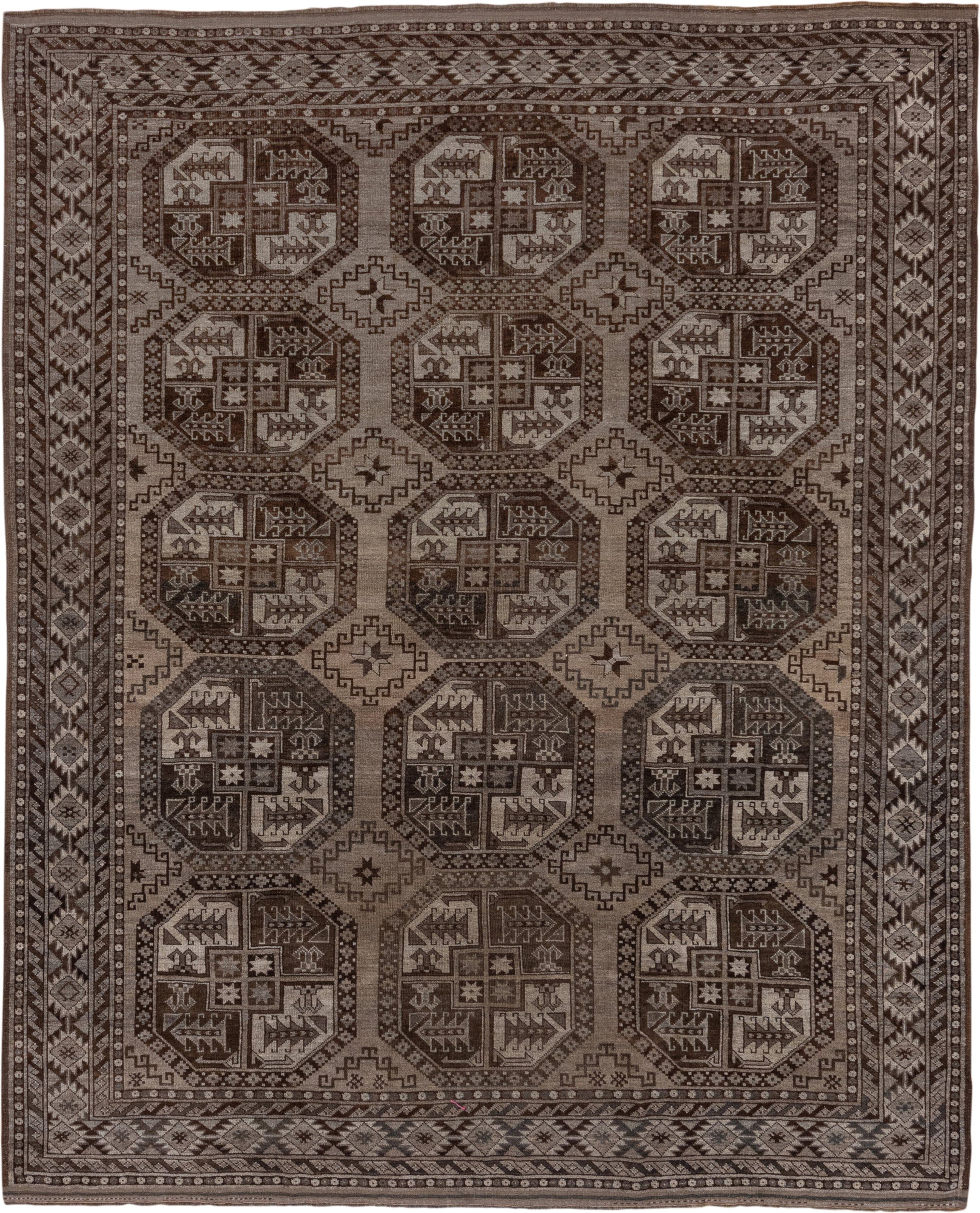 7' x 9' one-of-a-kind handmade antique Afghan rug. Color palette: brown, taupe, ivory, charcoal, camel, slate, beige, gray
