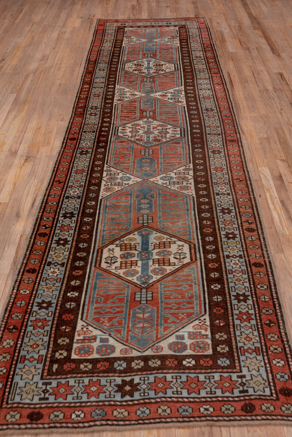 3' x 13' one-of-a-kind handmade antique Sarab runner rug. Color palette: ivory, rust, sky_blue, mahogany, brown, slate_blue