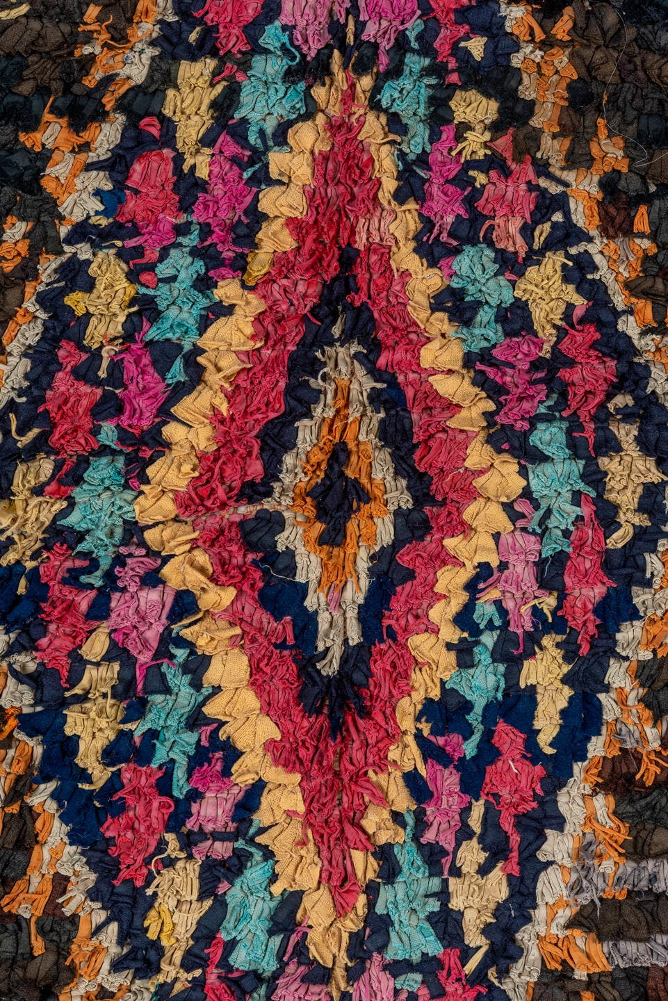 4' x 8' one-of-a-kind handmade vintage Rag Rug rug. Color palette: charcoal, hot pink, orange, turquoise, gold, cream, black