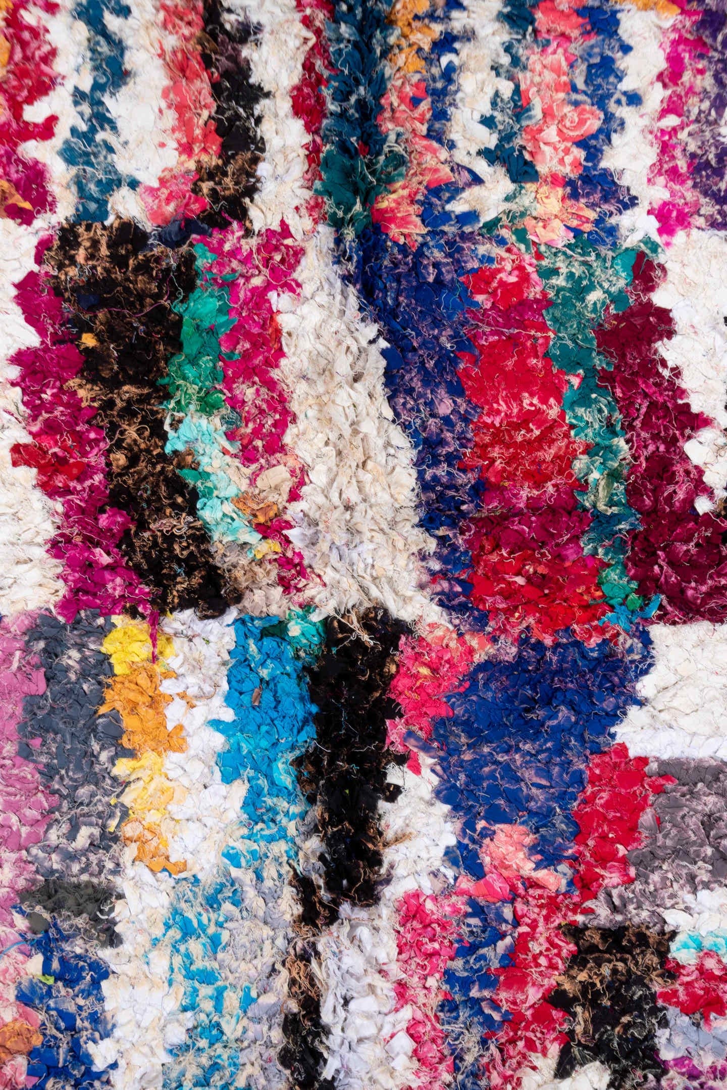 4' x 8' one-of-a-kind handmade vintage Rag Rug rug. Color palette: ivory, magenta, turquoise, cobalt, black, rose, lavender