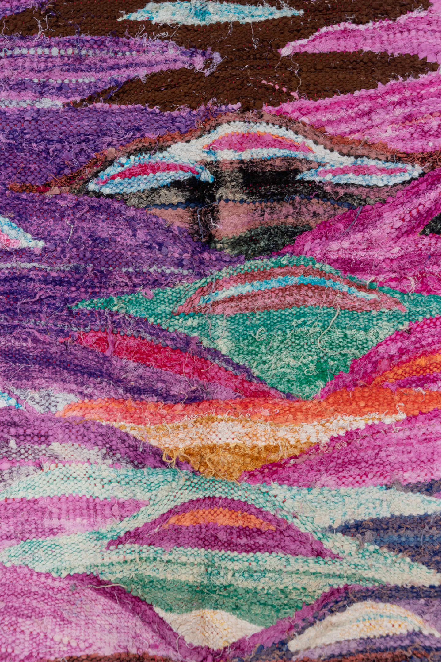 4' x 7' one-of-a-kind handmade vintage Rag Rug rug. Color palette: magenta, purple, pink, brown, turquoise, ivory, navy