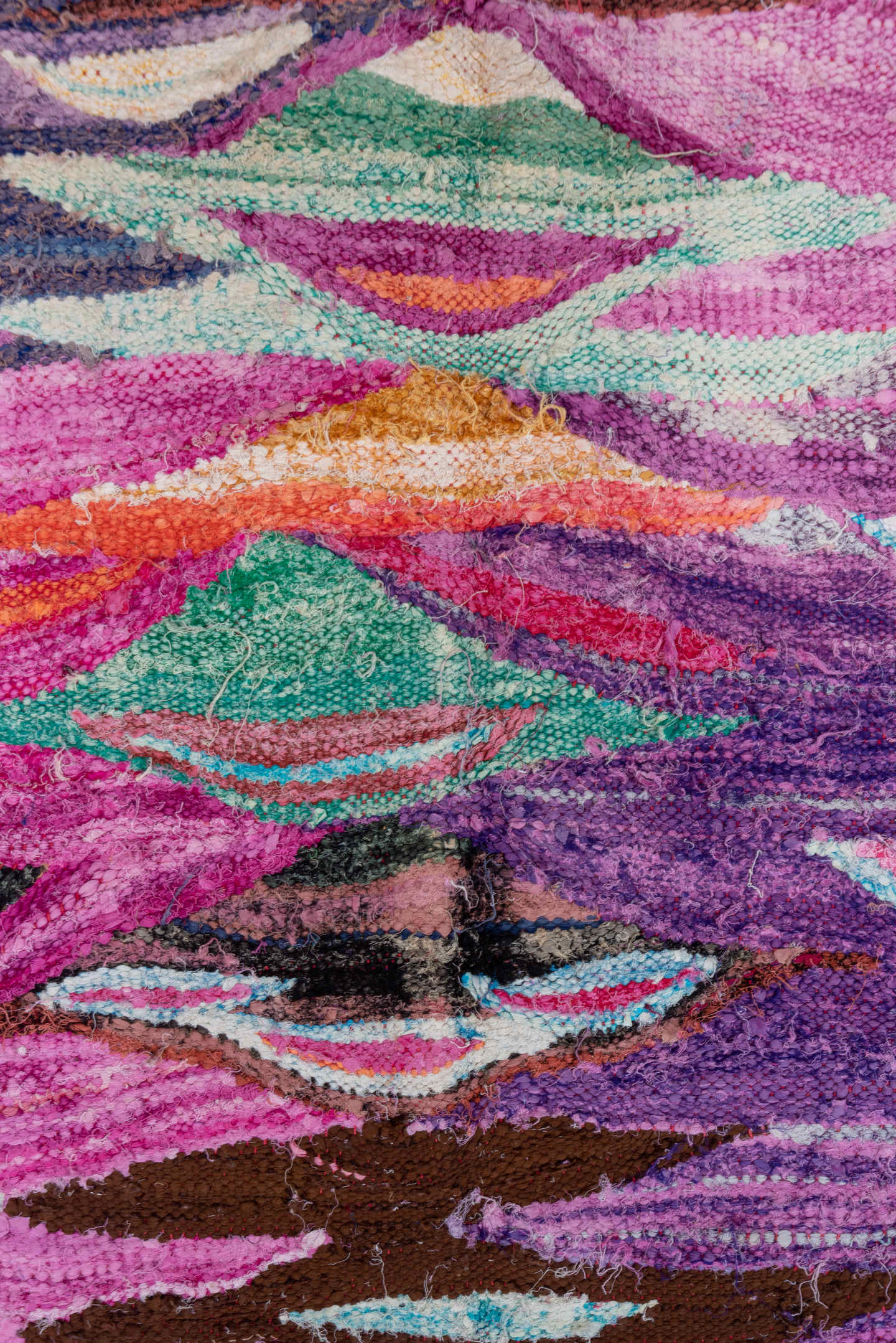 4' x 7' one-of-a-kind handmade vintage Rag Rug rug. Color palette: magenta, purple, pink, brown, turquoise, ivory, navy