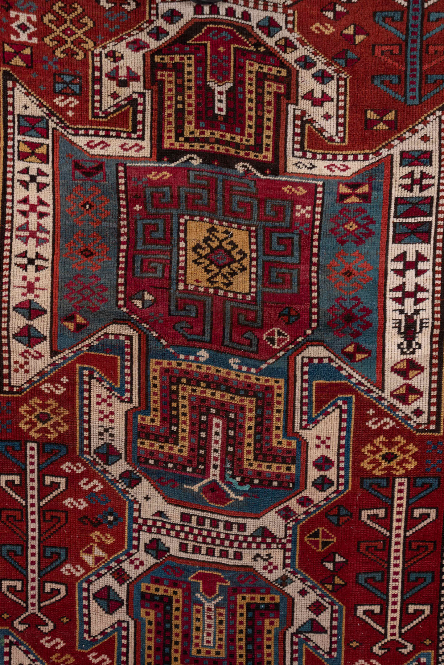 4' x 10' one-of-a-kind handmade antique Caucasian runner rug. Color palette: rust, ivory, indigo, crimson, sky_blue, gold
