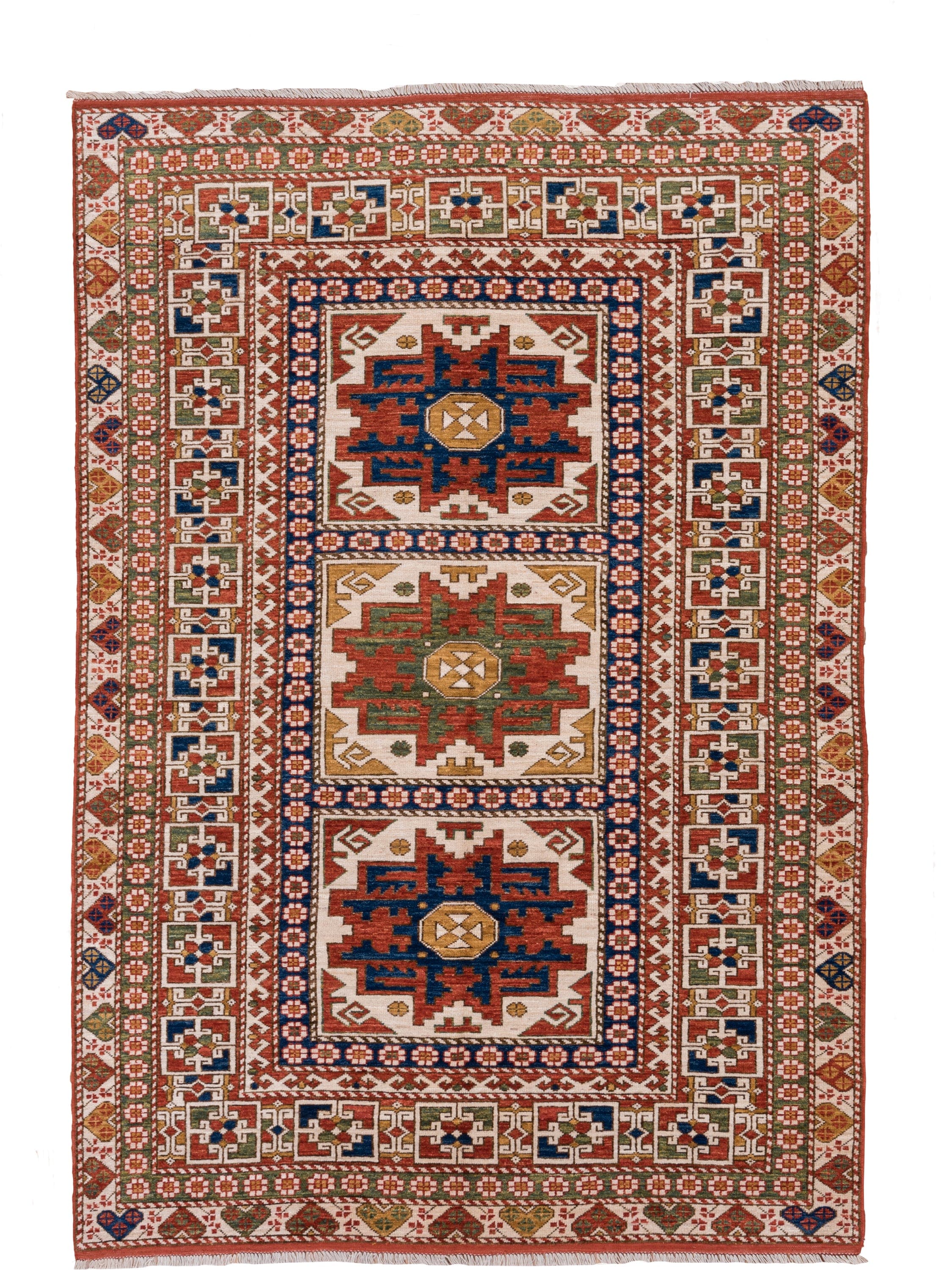 4' x 7' one-of-a-kind handmade vintage Kazak rug. Color palette: ivory, rust, indigo, olive, gold, terra cotta, terracotta