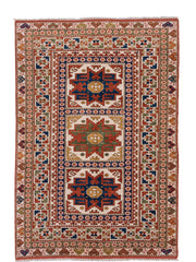 4' x 7' one-of-a-kind handmade vintage Kazak rug. Color palette: ivory, rust, indigo, olive, gold, terra cotta, terracotta