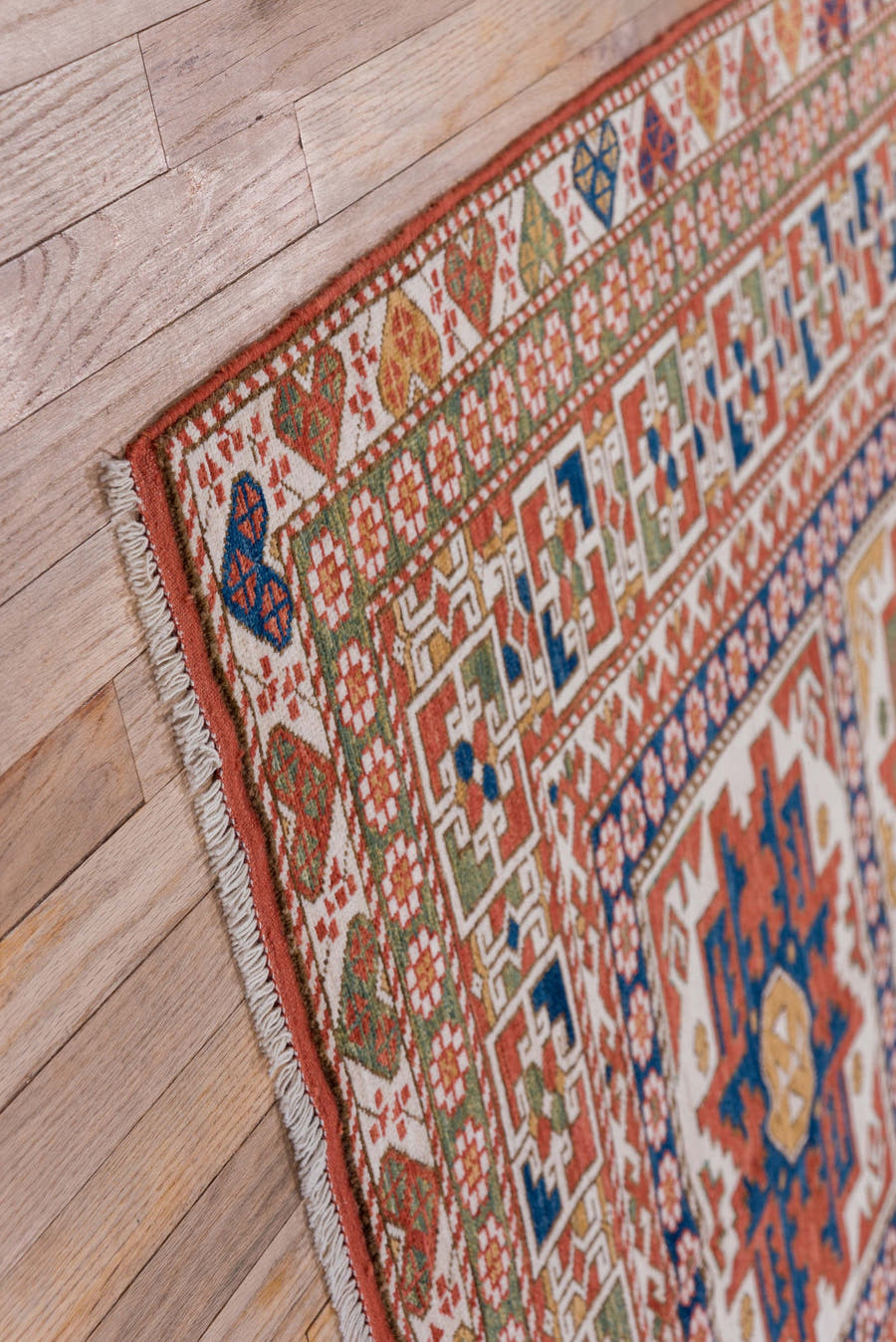 4' x 7' one-of-a-kind handmade vintage Kazak rug. Color palette: ivory, rust, indigo, olive, gold, terra cotta, terracotta