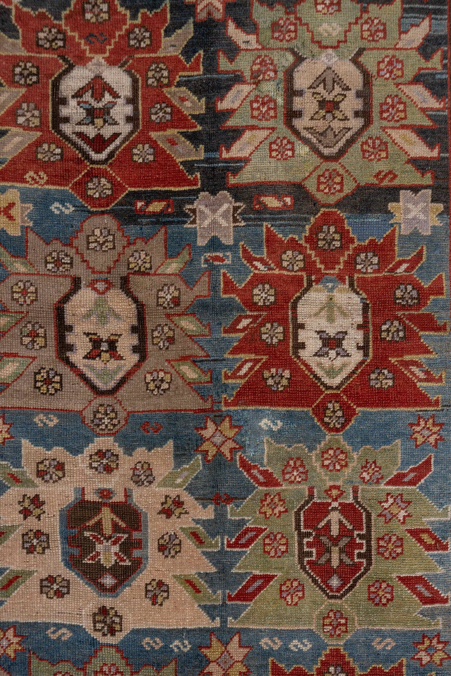 4' x 8' one-of-a-kind handmade antique Caucasian rug. Color palette: ivory, rust, brick, slate, sky_blue, camel, charcoal