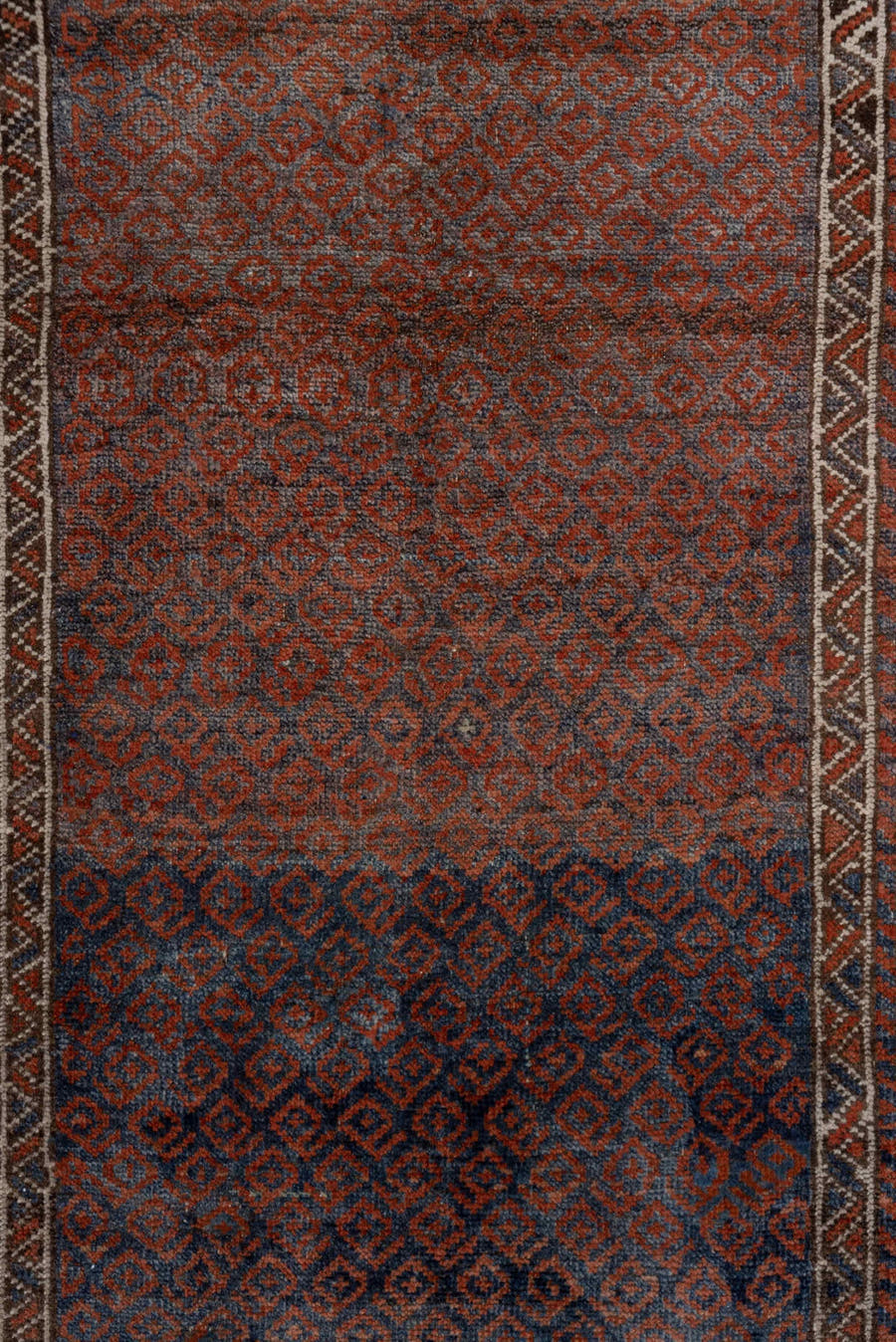 3' x 6' one-of-a-kind handmade antique Belouch small size rug. Color palette: rust, indigo, ivory, brown, charcoal