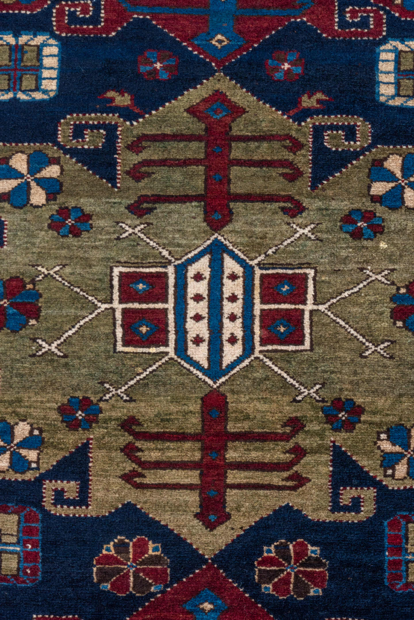 4' x 7' one-of-a-kind handmade antique Caucasian rug. Color palette: navy, crimson, ivory, cobalt, burgundy, camel, saffron