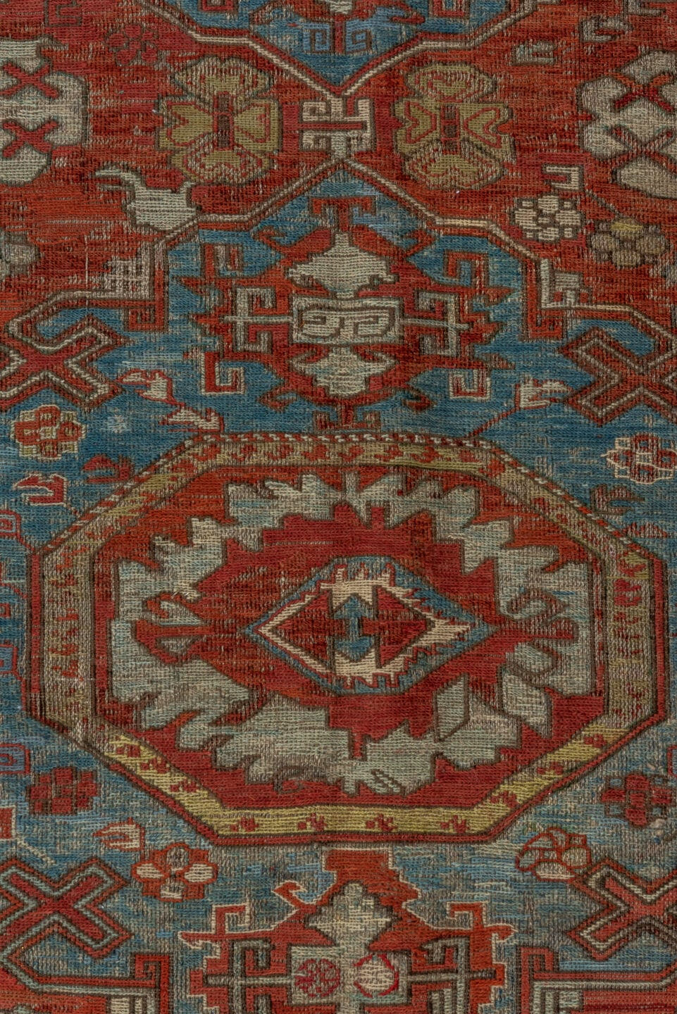 7' x 9' one-of-a-kind handmade antique Sumak rug. Color palette: rust, sky blue, ivory, beige, gold, brick, taupe