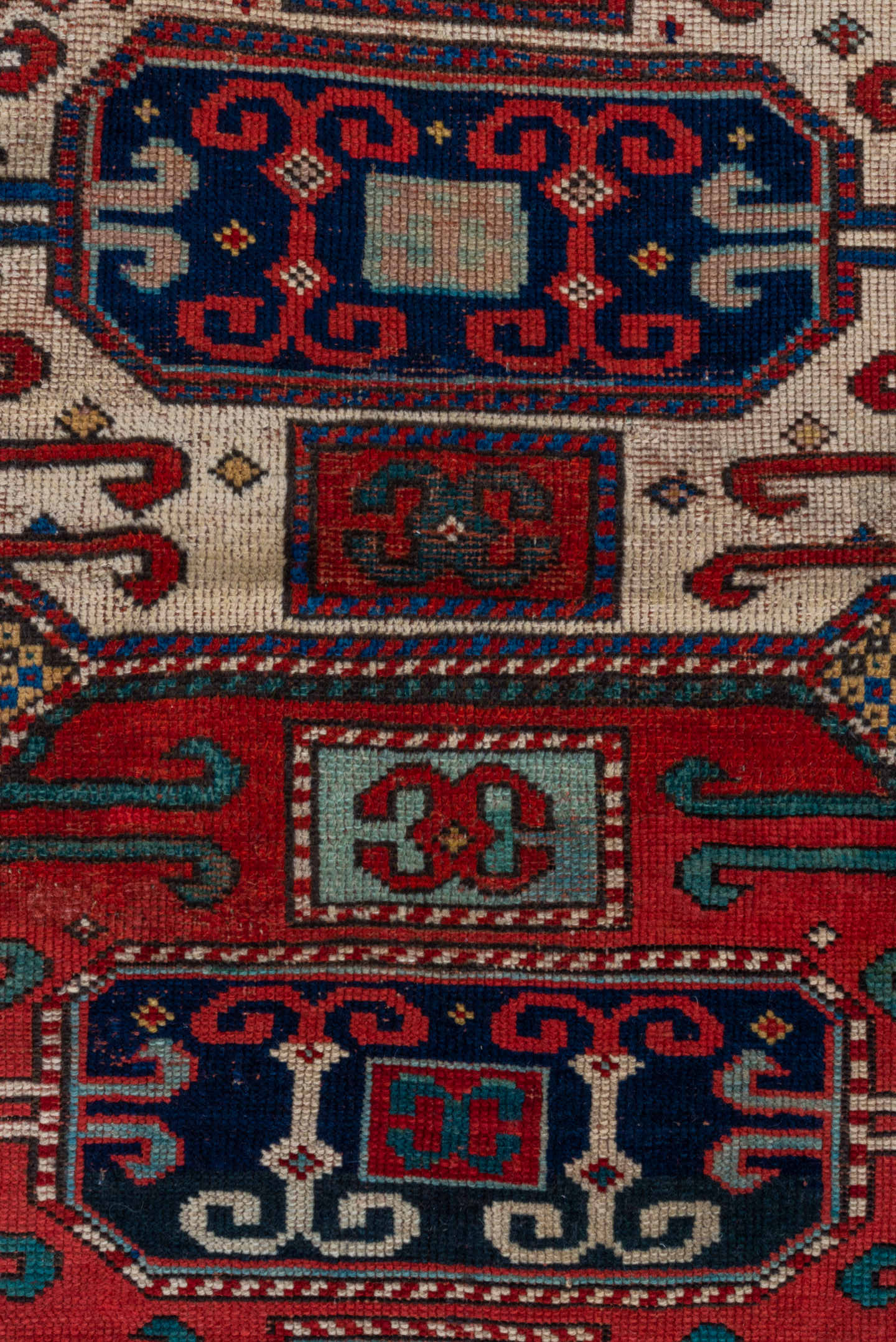 4' x 4' one-of-a-kind handmade antique Kazak small size rug. Color palette: ivory, red, navy, cobalt, teal, crimson, camel