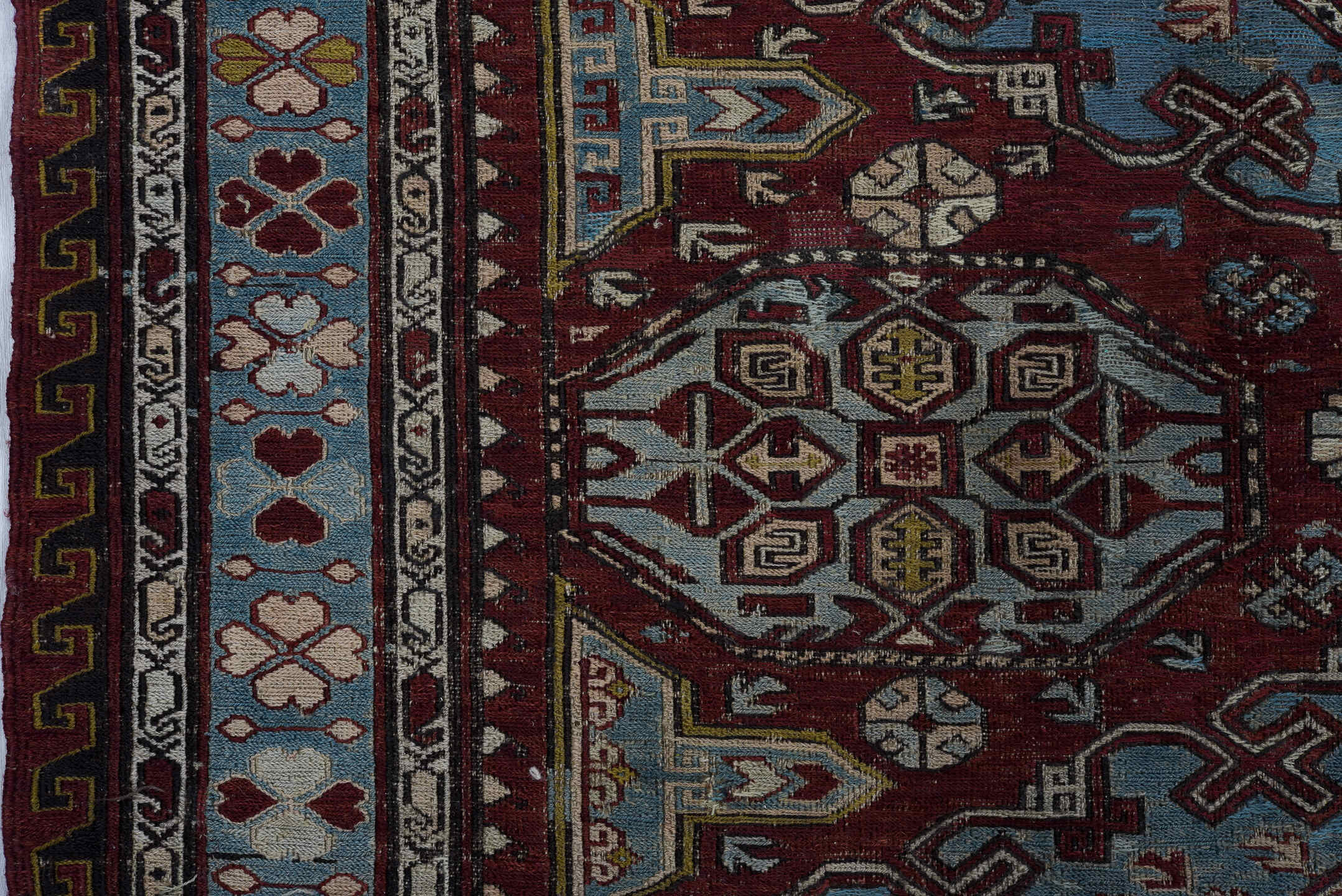 4' x 6' one-of-a-kind handmade antique Sumak rug. Color palette: rust, powder blue, ivory, charcoal, burgundy, camel, slate