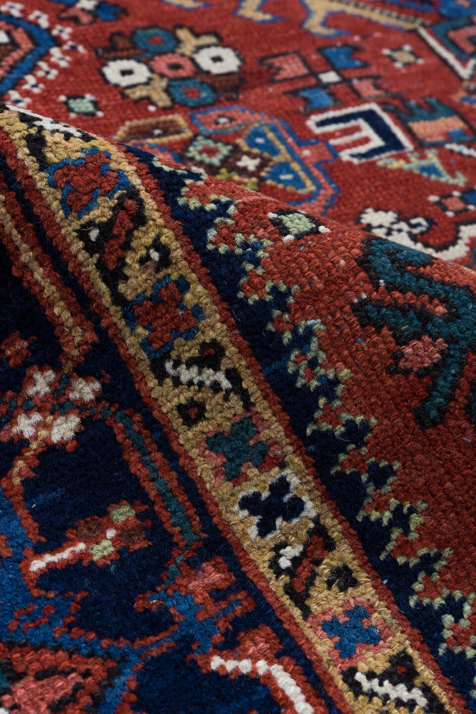 4' x 6' one-of-a-kind handmade vintage Karaje small size rug. Color palette: rust, navy, ivory, sky_blue, camel, rose