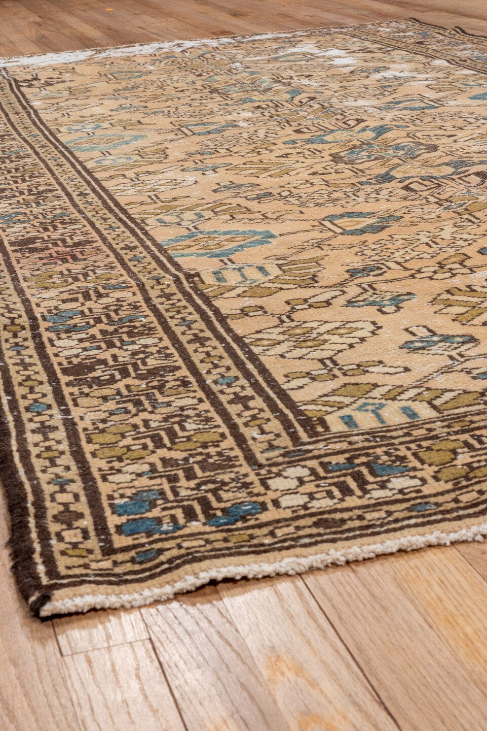 5' x 9' one-of-a-kind handmade vintage Distressed medium size rug. Color palette: tan, ivory, brown, muted blue, taupe