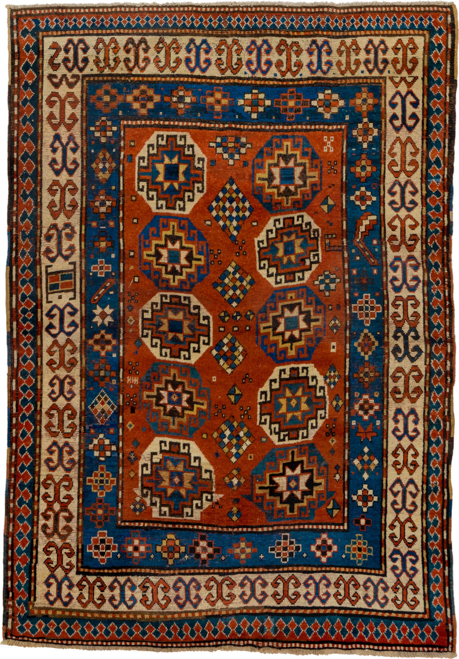 4' x 7' one-of-a-kind handmade antique Kazak rug. Color palette: rust, cobalt, ivory, camel, charcoal, gold, crimson