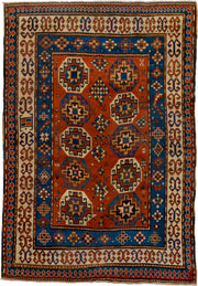 4' x 7' one-of-a-kind handmade antique Kazak rug. Color palette: rust, cobalt, ivory, camel, charcoal, gold, crimson