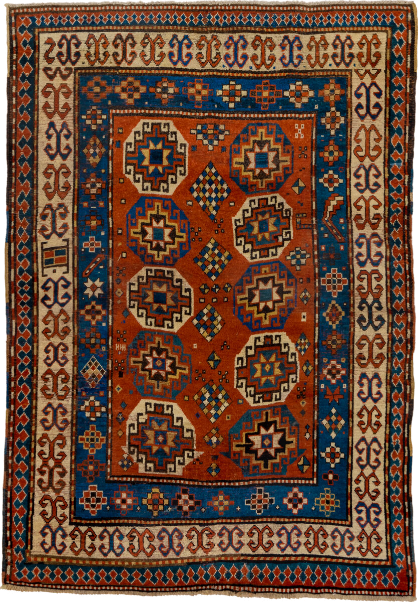 4' x 7' one-of-a-kind handmade antique Kazak rug. Color palette: rust, cobalt, ivory, camel, charcoal, gold, crimson