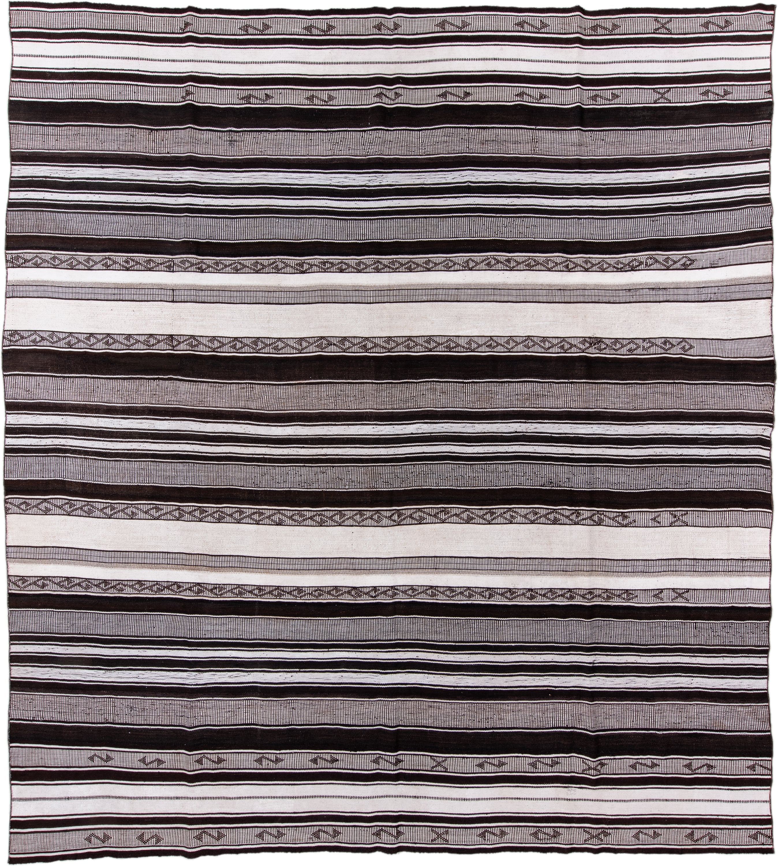 12' x 13' one-of-a-kind handmade antique Flatweave oversize rug. Color palette: ivory, charcoal, brown, taupe, gray, black