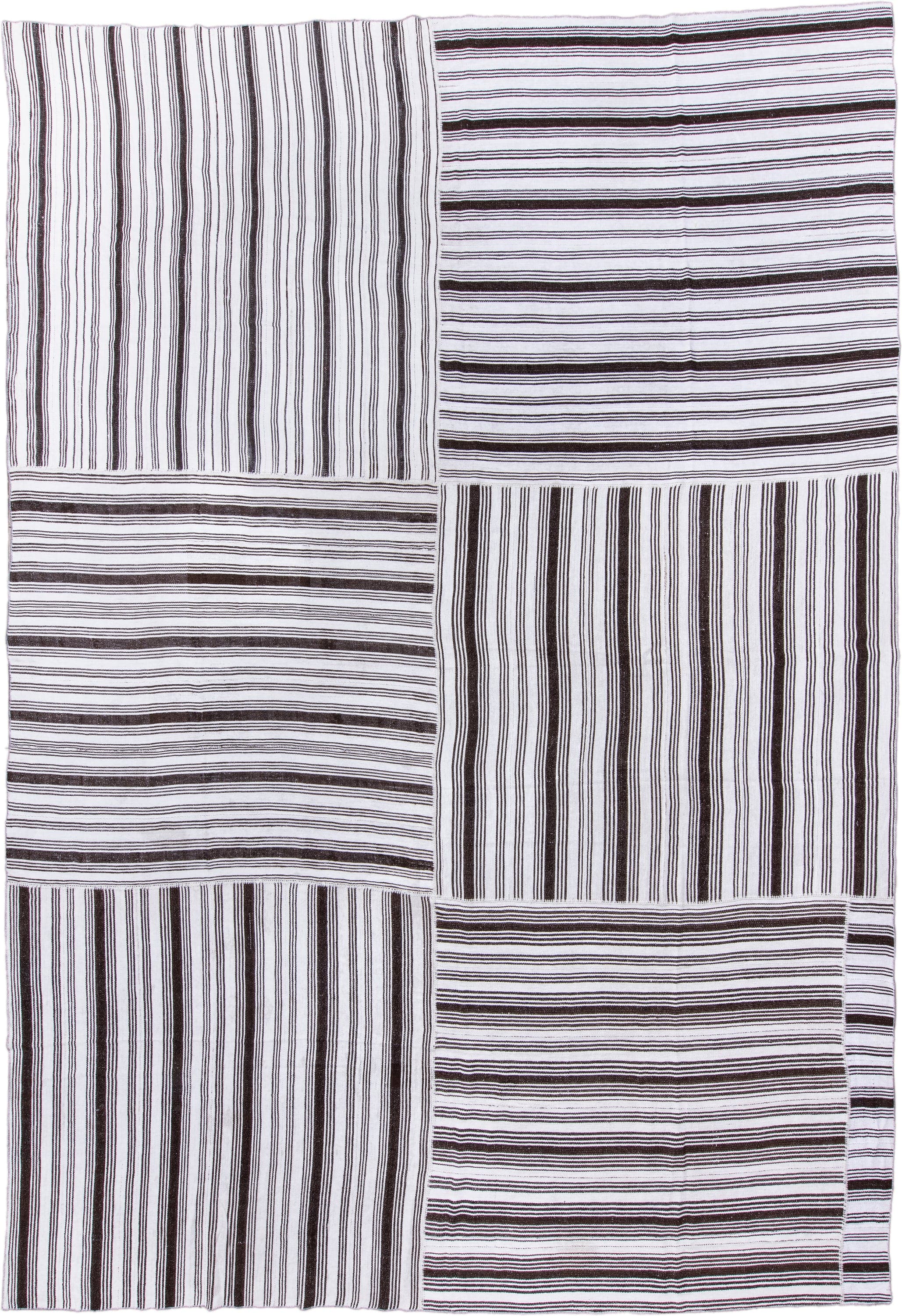 12' x 18' one-of-a-kind handmade antique Flatweave oversize rug. Color palette: ivory, dark brown, brown