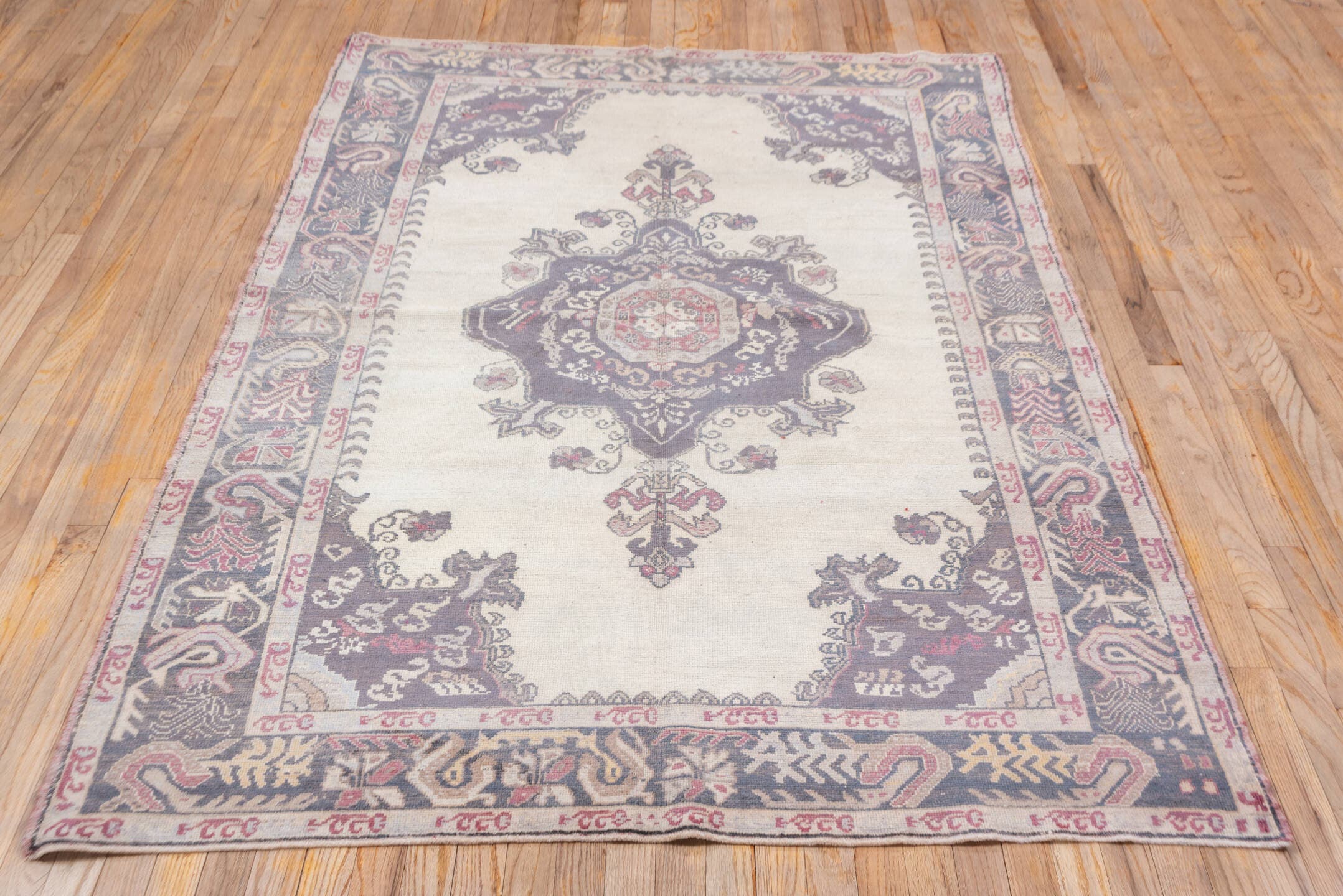 5' x 7' one-of-a-kind handmade vintage Oushak rug. Color palette: ivory, plum, slate, rose, taupe, burgundy, pink, purple