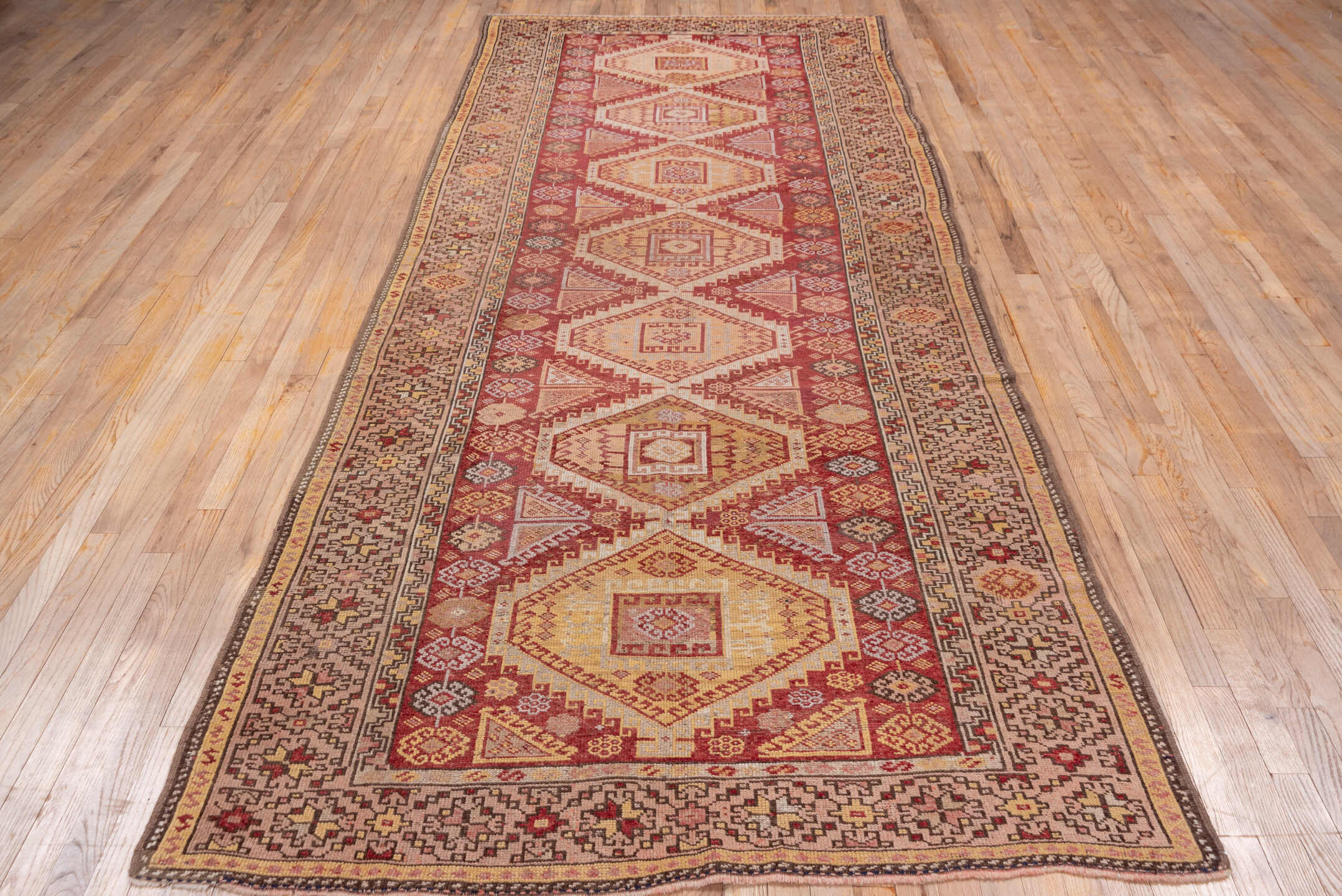 4' x 11' one-of-a-kind handmade vintage Kurd runner rug. Color palette: terra cotta, ivory, rust, rose, camel, taupe, brown