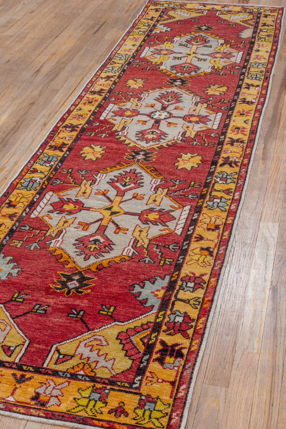 2' x 9' one-of-a-kind handmade vintage Oushak runner rug. Color palette: red, gold, ivory, rust, saffron, charcoal, rose