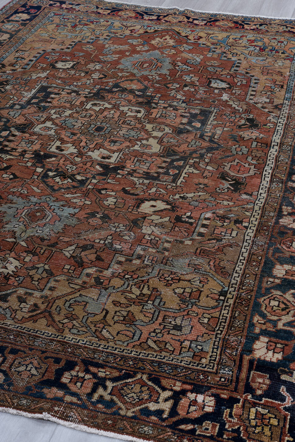 6' x 9' one-of-a-kind handmade antique Heriz medium size rug. Color palette: terra cotta, navy, ivory, slate, taupe, rust