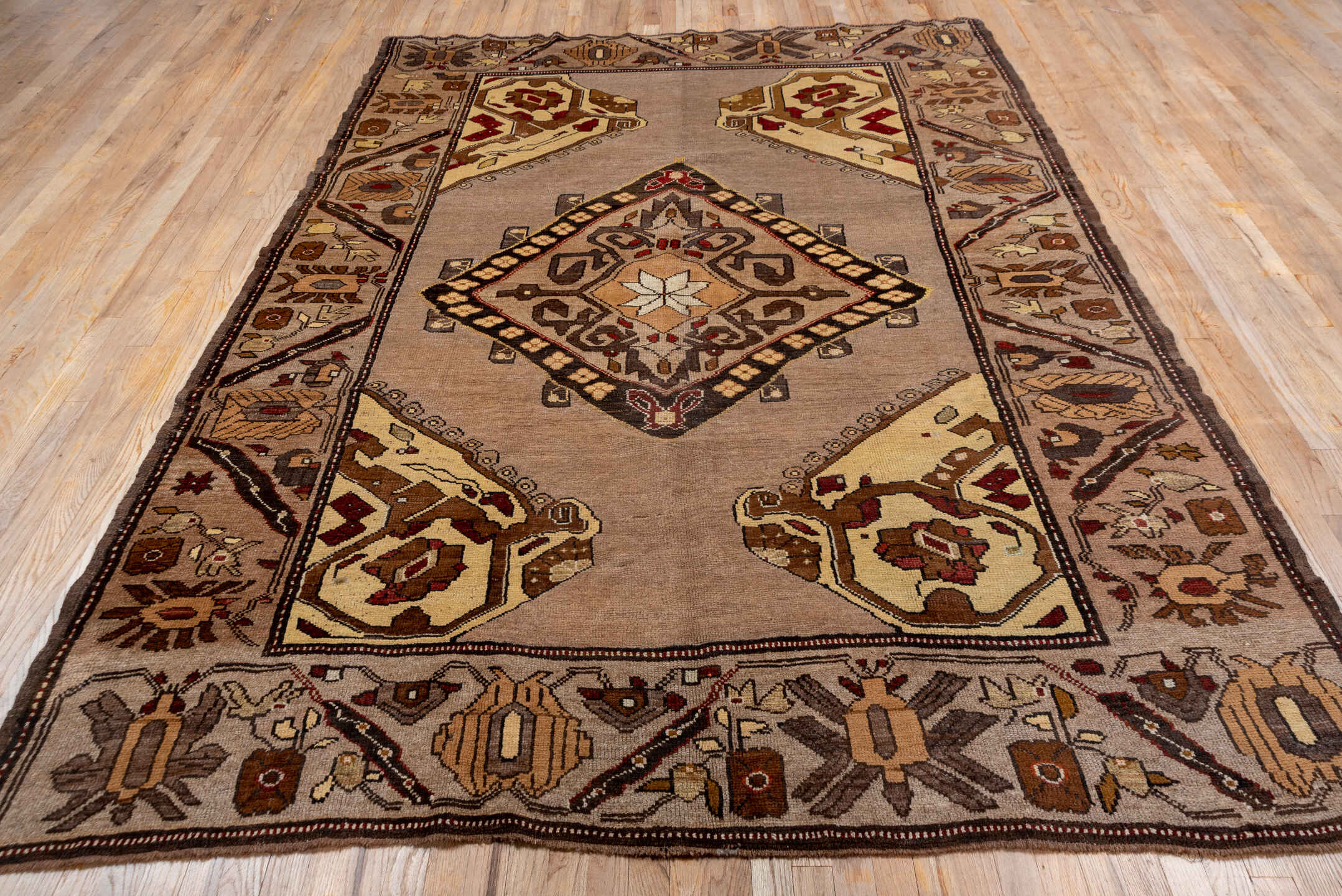 7' x 9' one-of-a-kind handmade vintage Kars rug. Color palette: taupe, brown, ivory, walnut, rust, charcoal, camel, burgundy