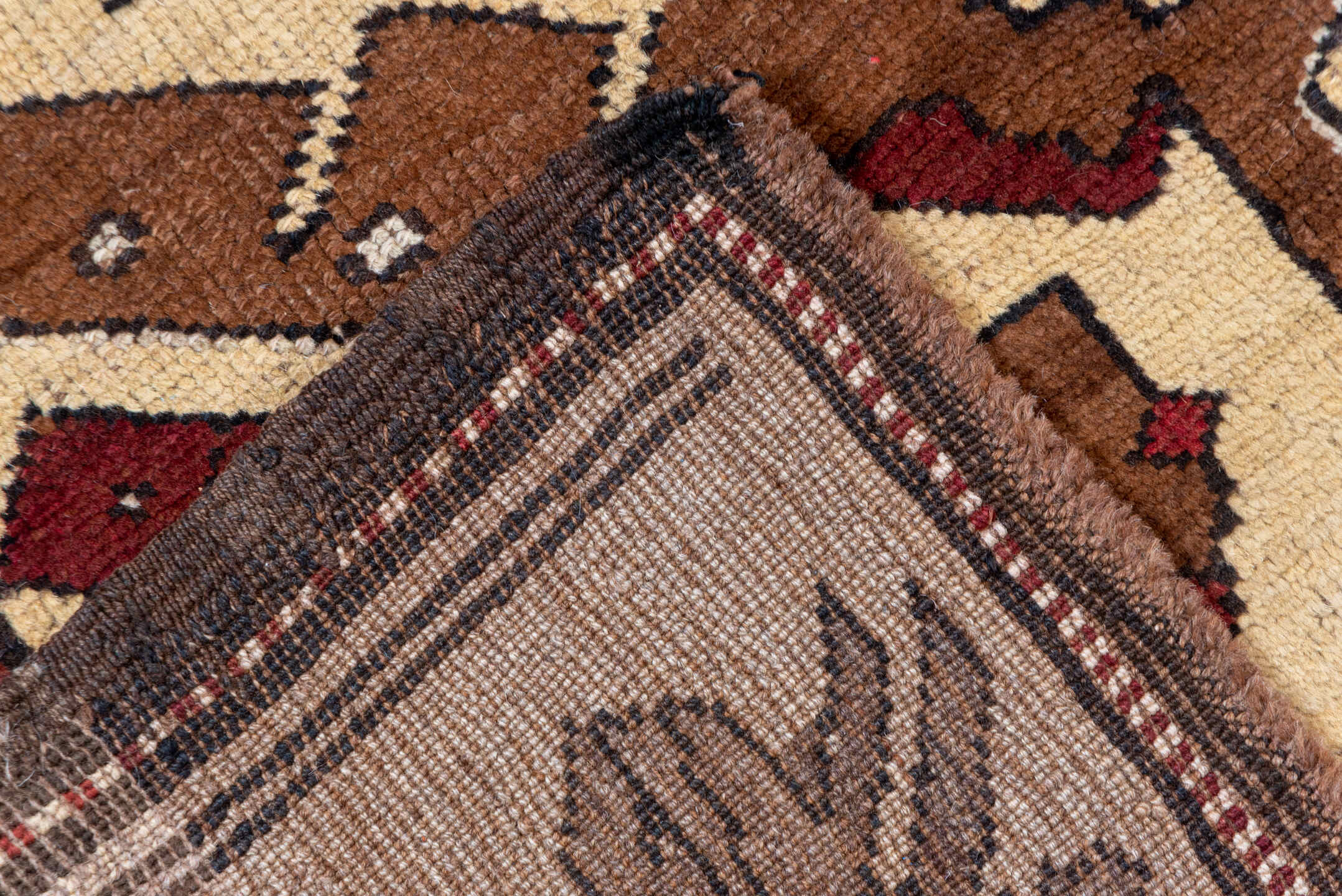 7' x 9' one-of-a-kind handmade vintage Kars rug. Color palette: taupe, brown, ivory, walnut, rust, charcoal, camel, burgundy