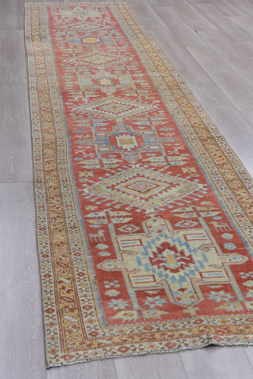 3' x 14' one-of-a-kind handmade antique Heriz runner rug. Color palette: terra cotta, ivory, sky blue, camel, slate, rust