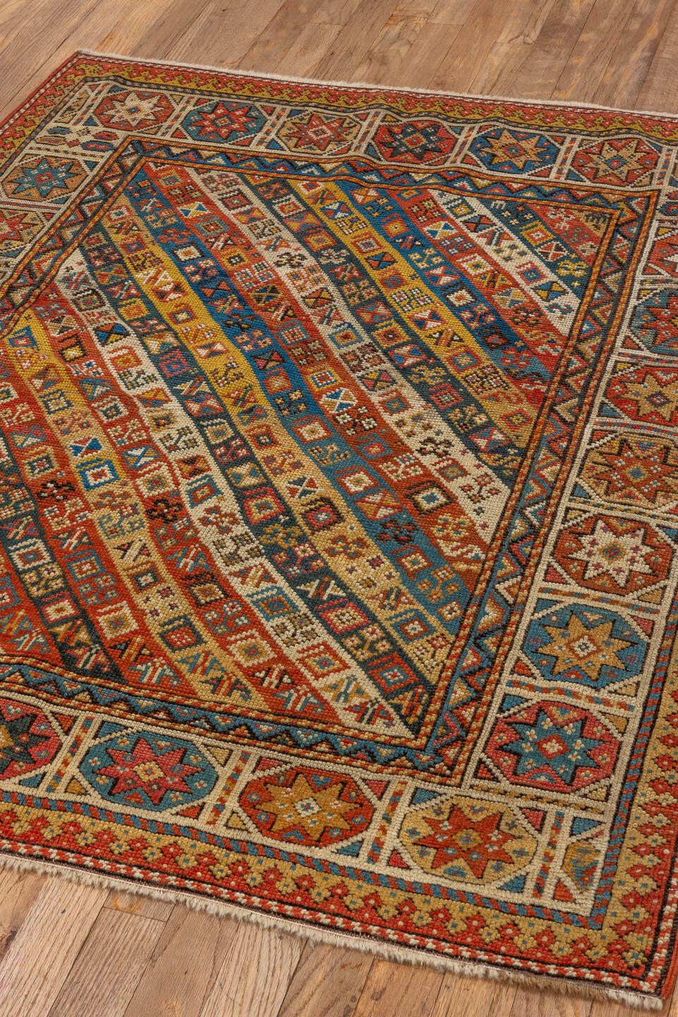 3' x 4' one-of-a-kind handmade antique Kazak small size rug. Color palette: ivory, rust, sky_blue, gold, navy, terra_cotta