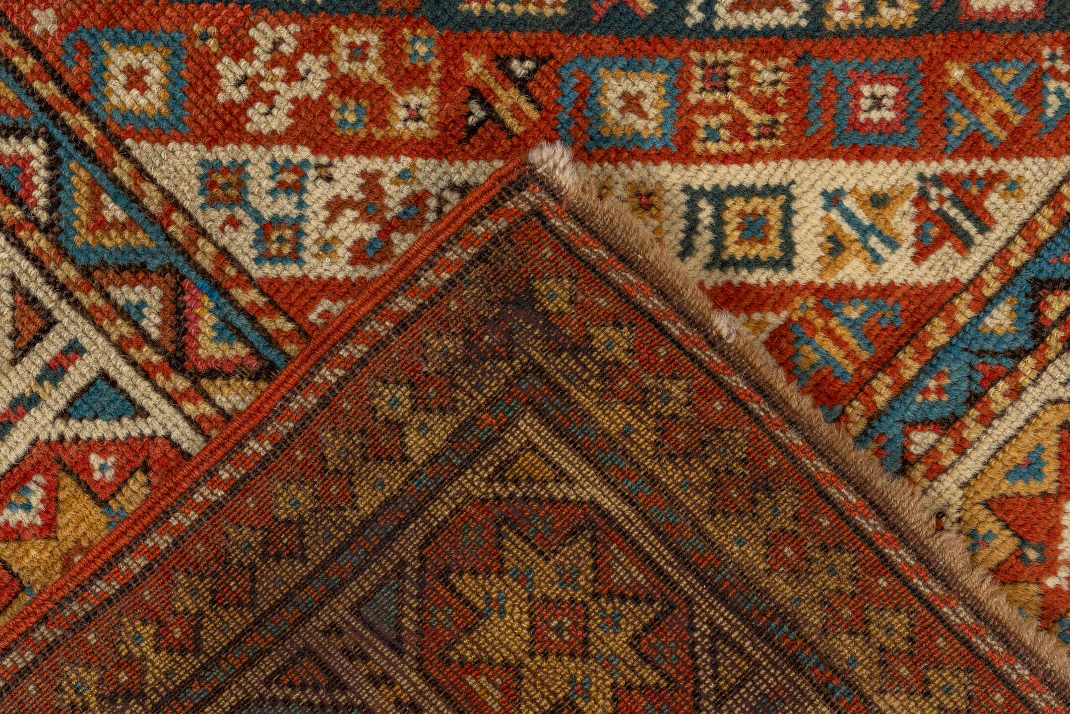 3' x 4' one-of-a-kind handmade antique Kazak small size rug. Color palette: ivory, rust, sky_blue, gold, navy, terra_cotta