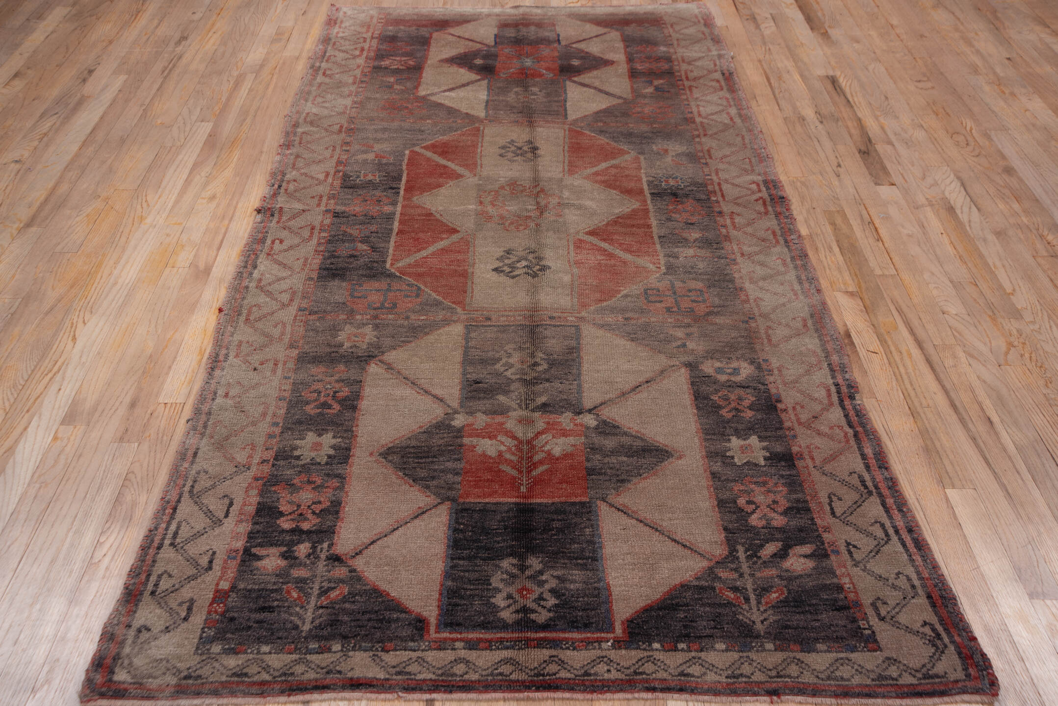 4' x 9' one-of-a-kind handmade vintage Oushak runner rug. Color palette: black, brown, charcoal, gray, pink, red, redwood