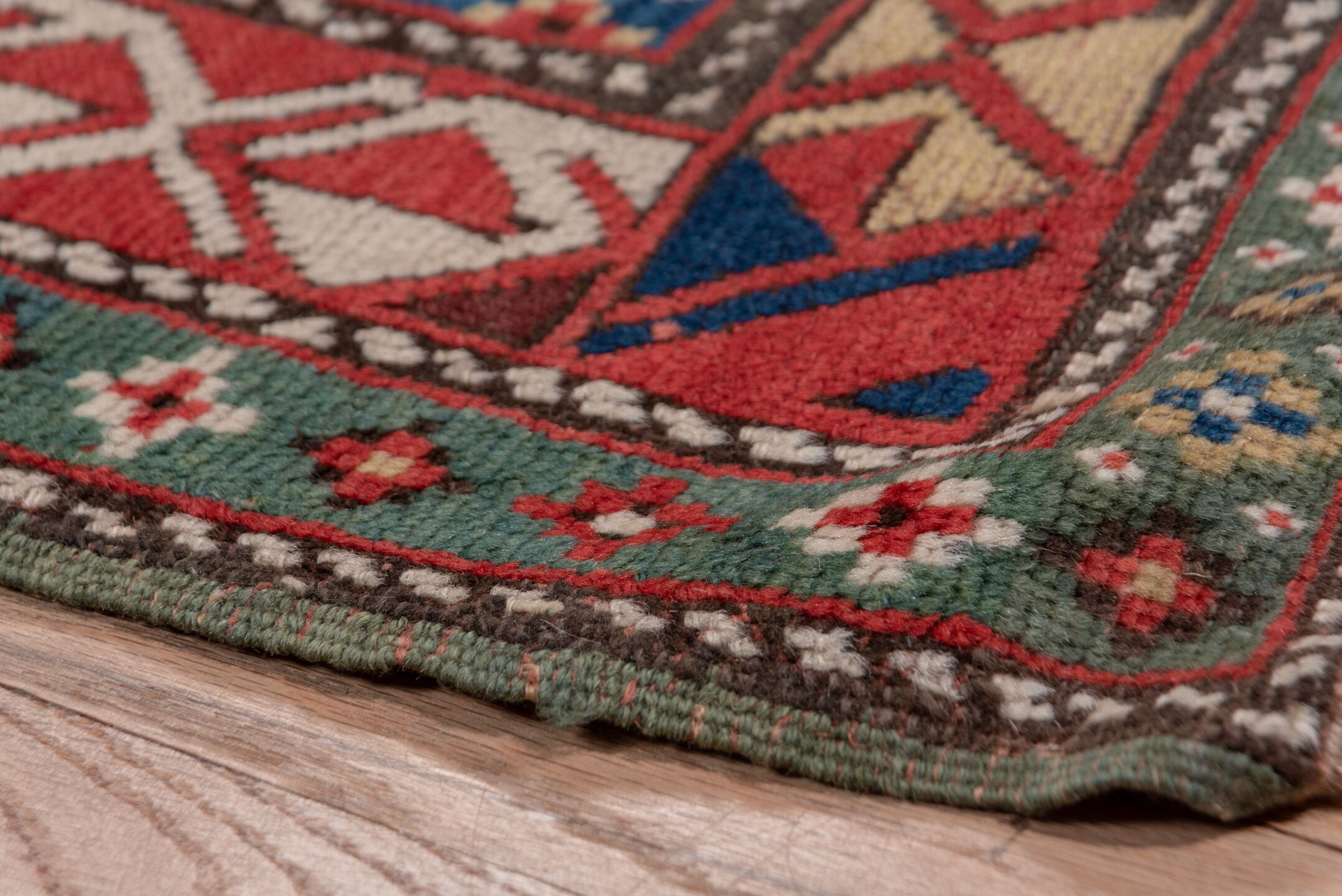 3' x 12' one-of-a-kind handmade vintage Genje runner rug. Color palette: black, blue, brown, gray, pink, red