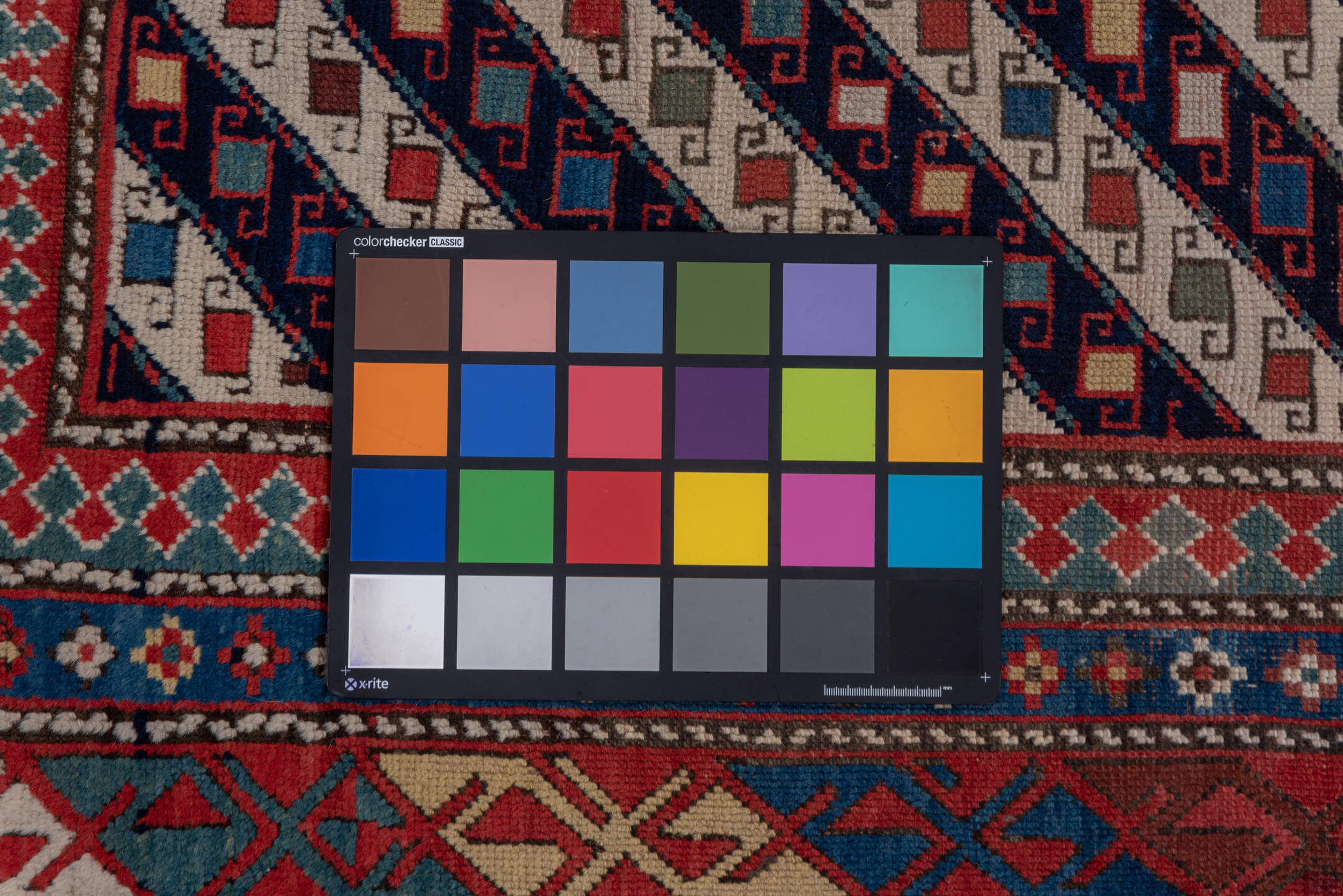 3' x 12' one-of-a-kind handmade vintage Genje runner rug. Color palette: black, blue, brown, gray, pink, red