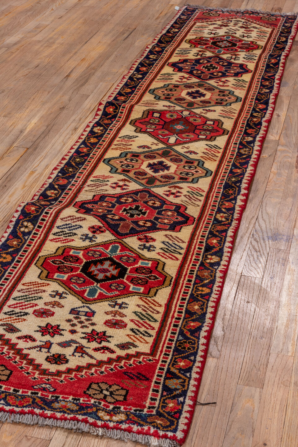2' x 10' one-of-a-kind handmade vintage Veece runner rug. Color palette: ivory, navy, rust, rose, crimson, camel, charcoal